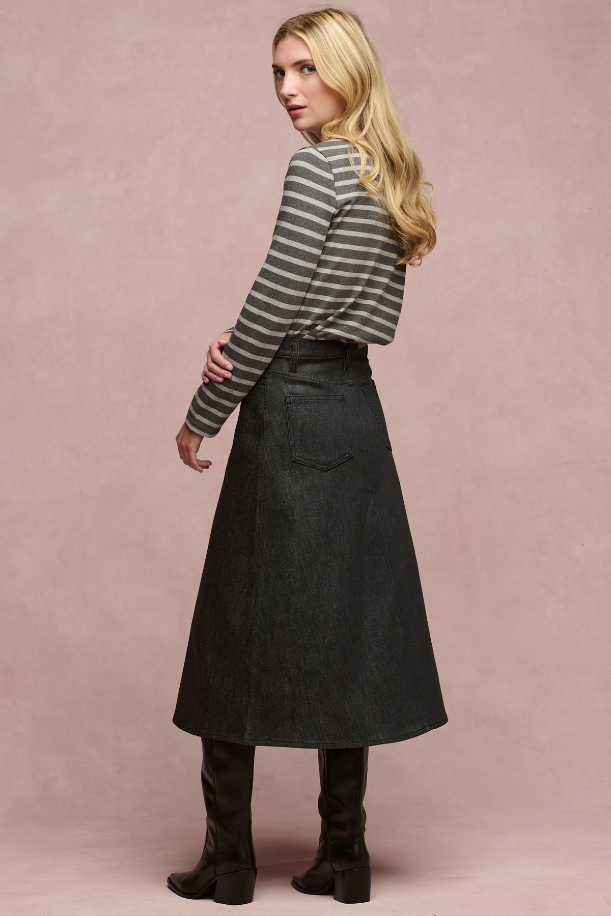 
            Full body image of the side female wearing Bobbie a line denim skirt in black with black boots