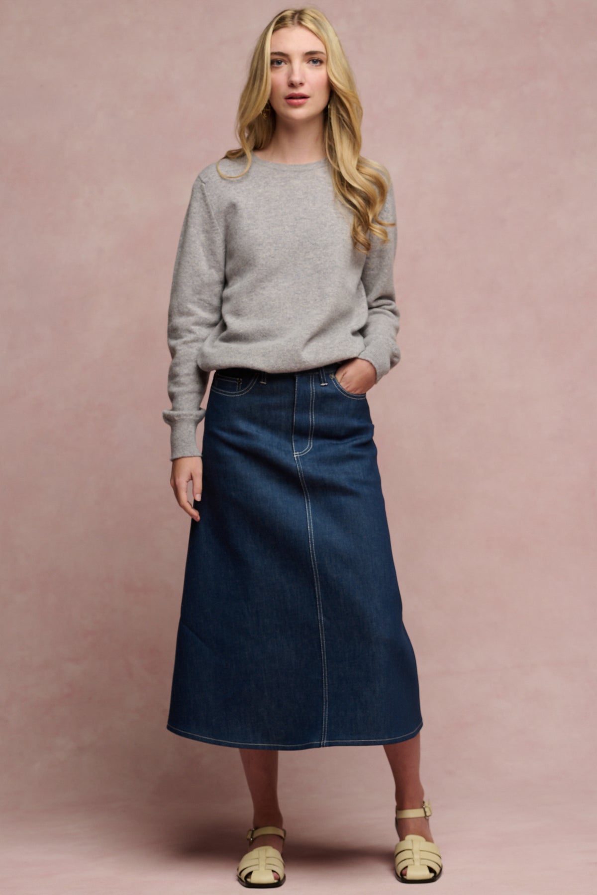 
            Full body image of female wearing Bobbie a line midi skirt in blue paired with grey lambswool crew neck