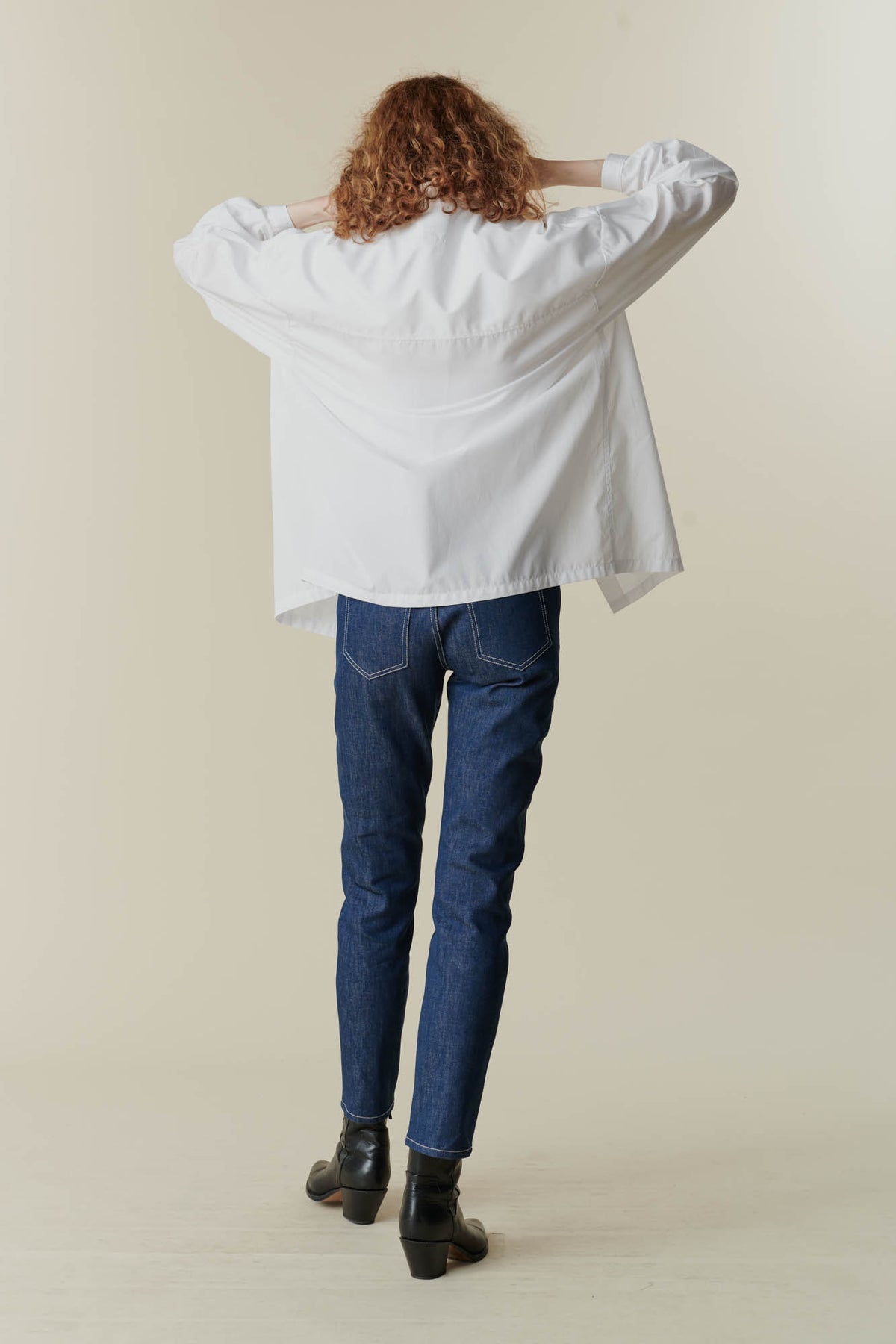 
            behind image of woman wearing esme long sleeve white shirt and some blue community clothing jeans