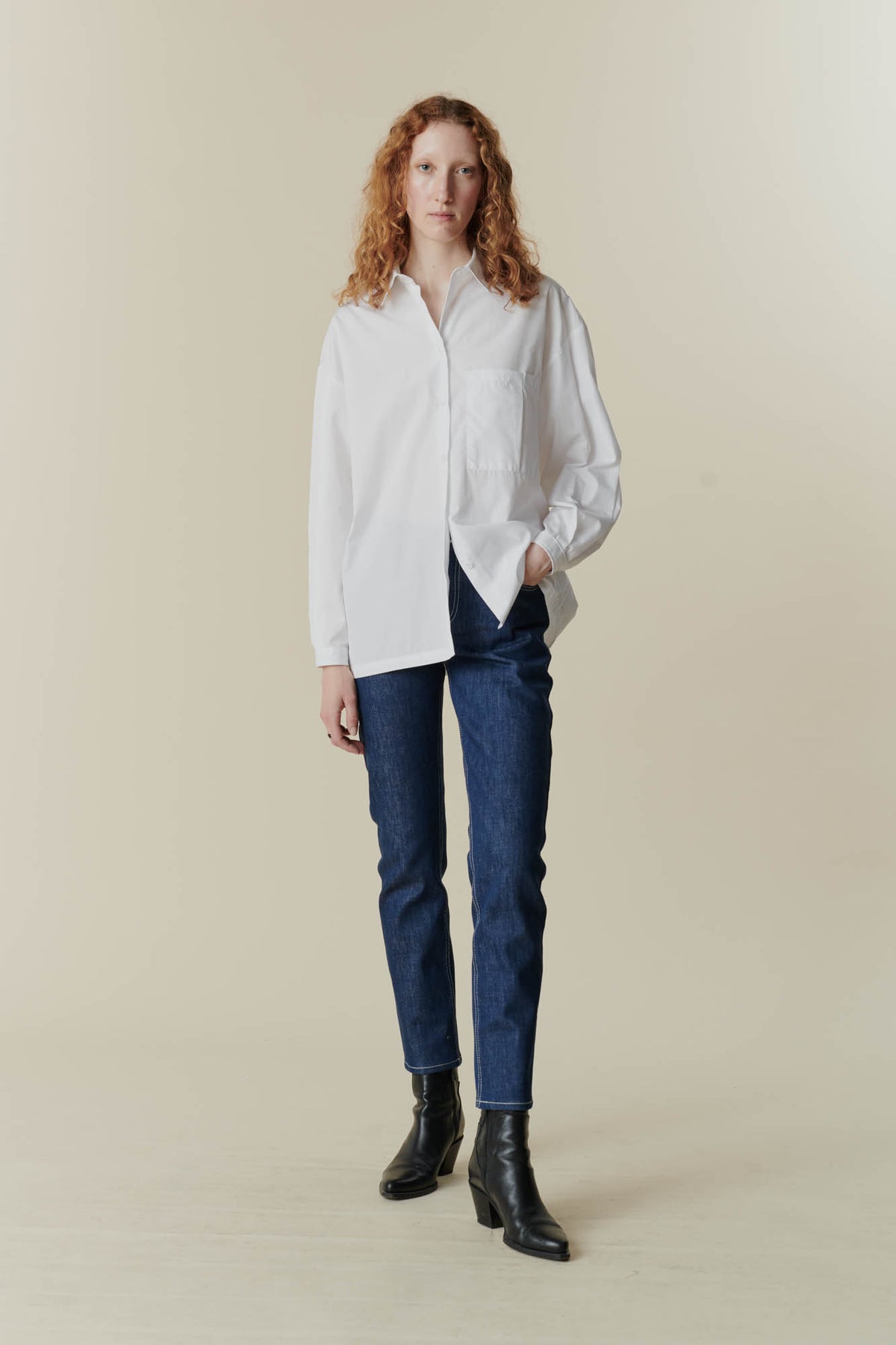 
            female wearing white esme shirt and some high rise jeans from community clothing