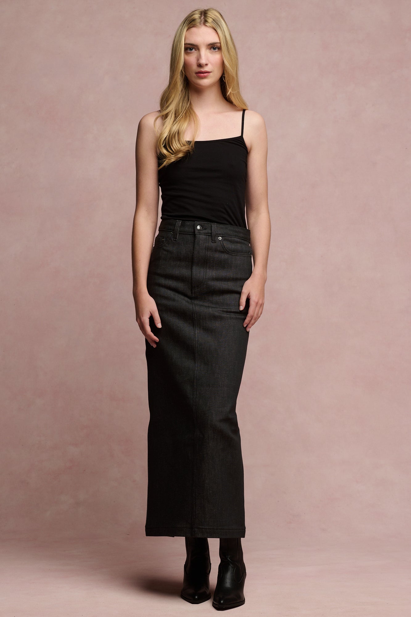 Blonde female wearing Frankie denim maxi skirt in black with black camisole tucked in paired with black boots