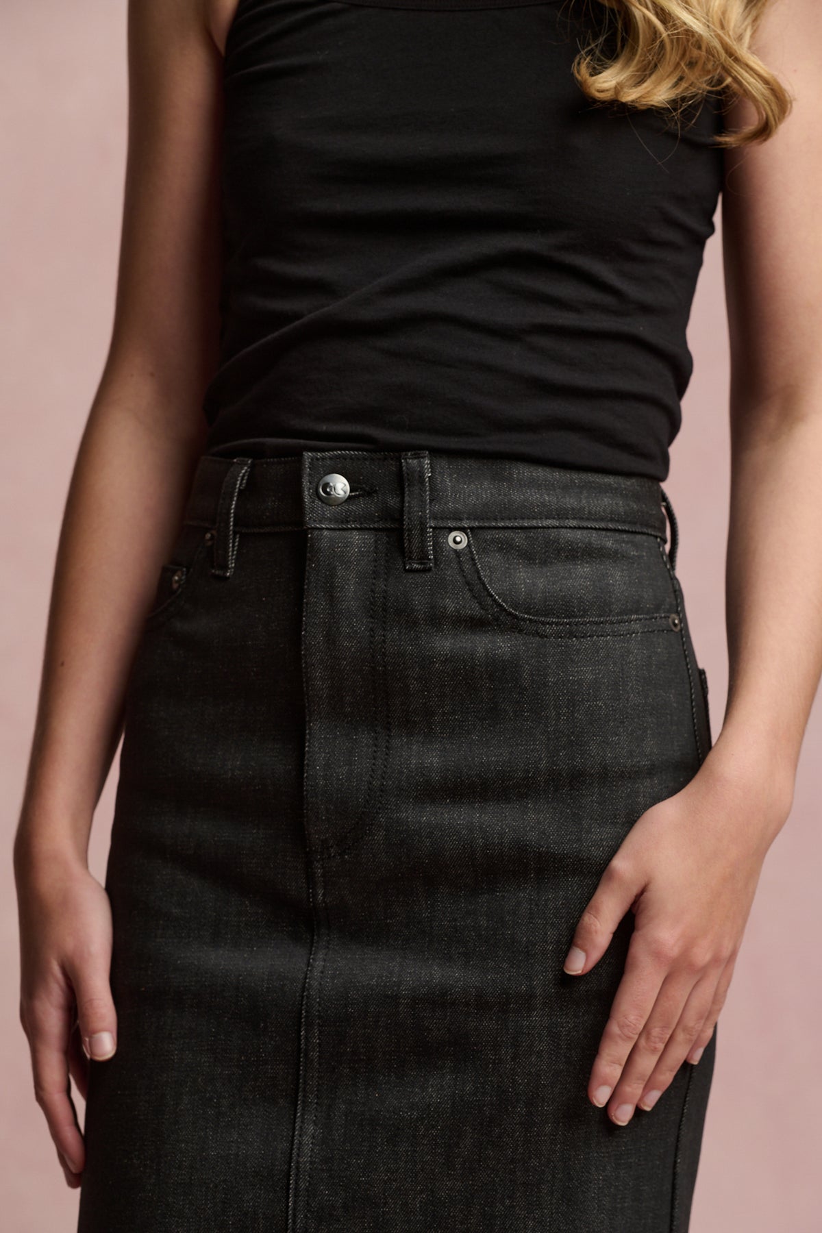 
            Image showing the chest to thigh of blonde female wearing Frankie denim maxi skirt with black camisole tucked in