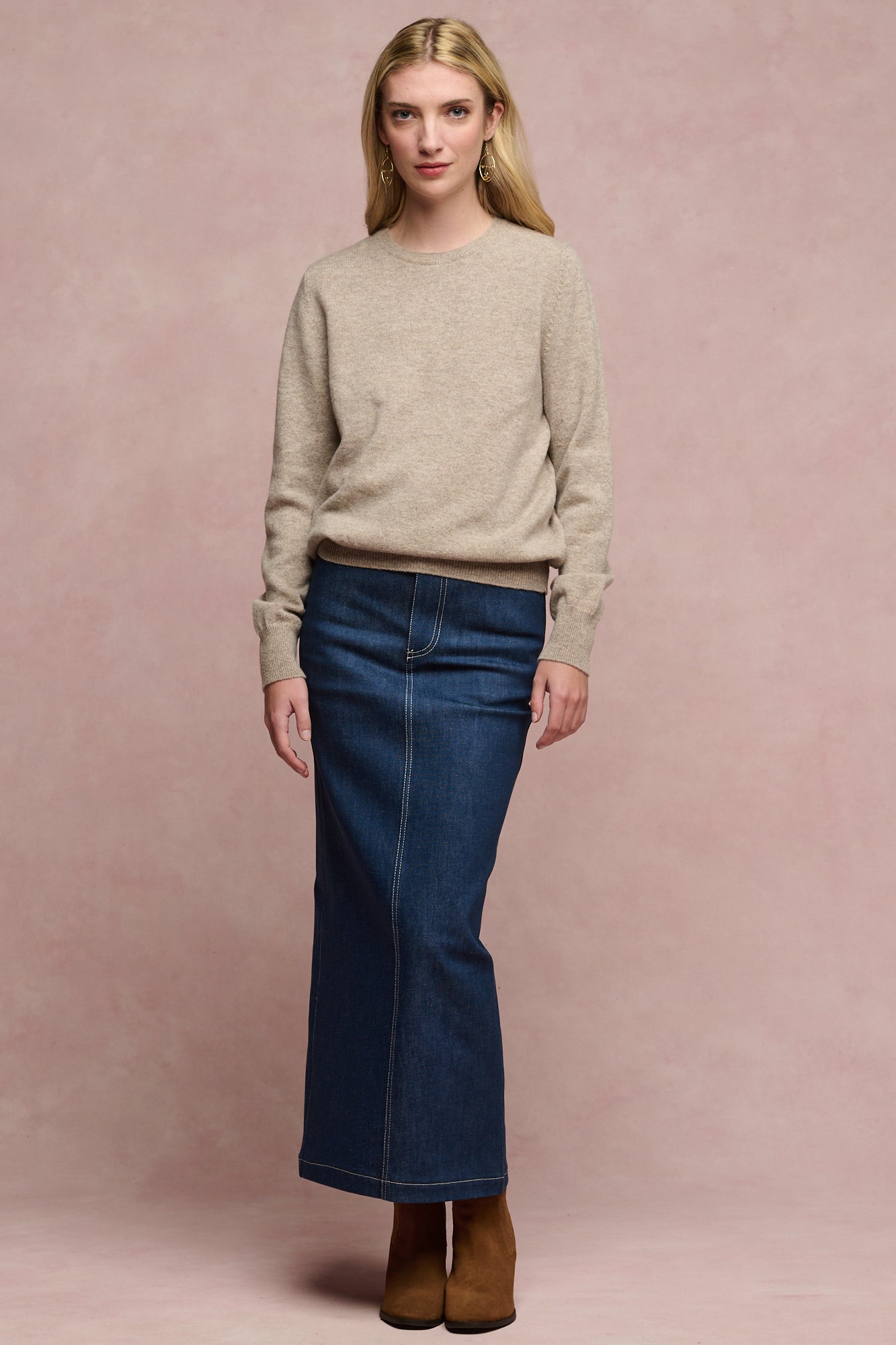 Full body image of female wearing Frankie denim maxi skirt in blue paired with lambswool crew neck jumper and brown suede boots