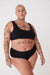 tattooed, plus size, white female in black high rise brief