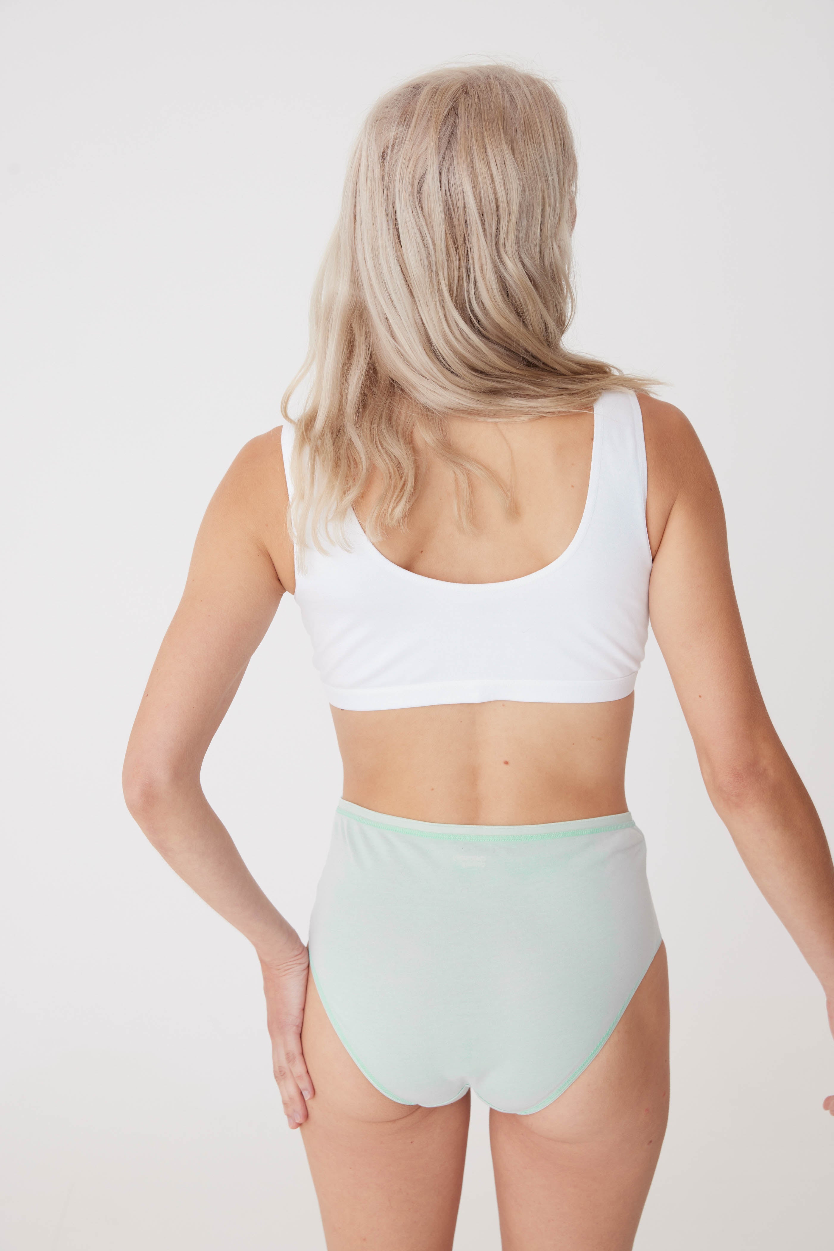 blonde, white female wearing high rise brief in sage