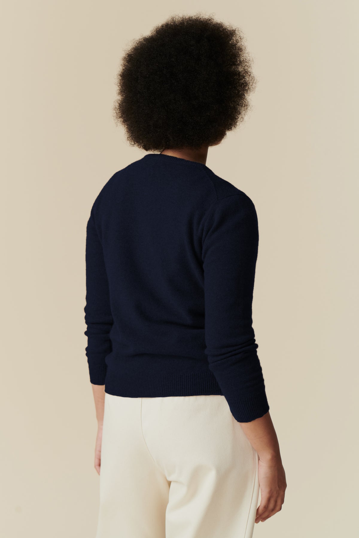 
            Image of back of female wearing lambswool crew neck in navy