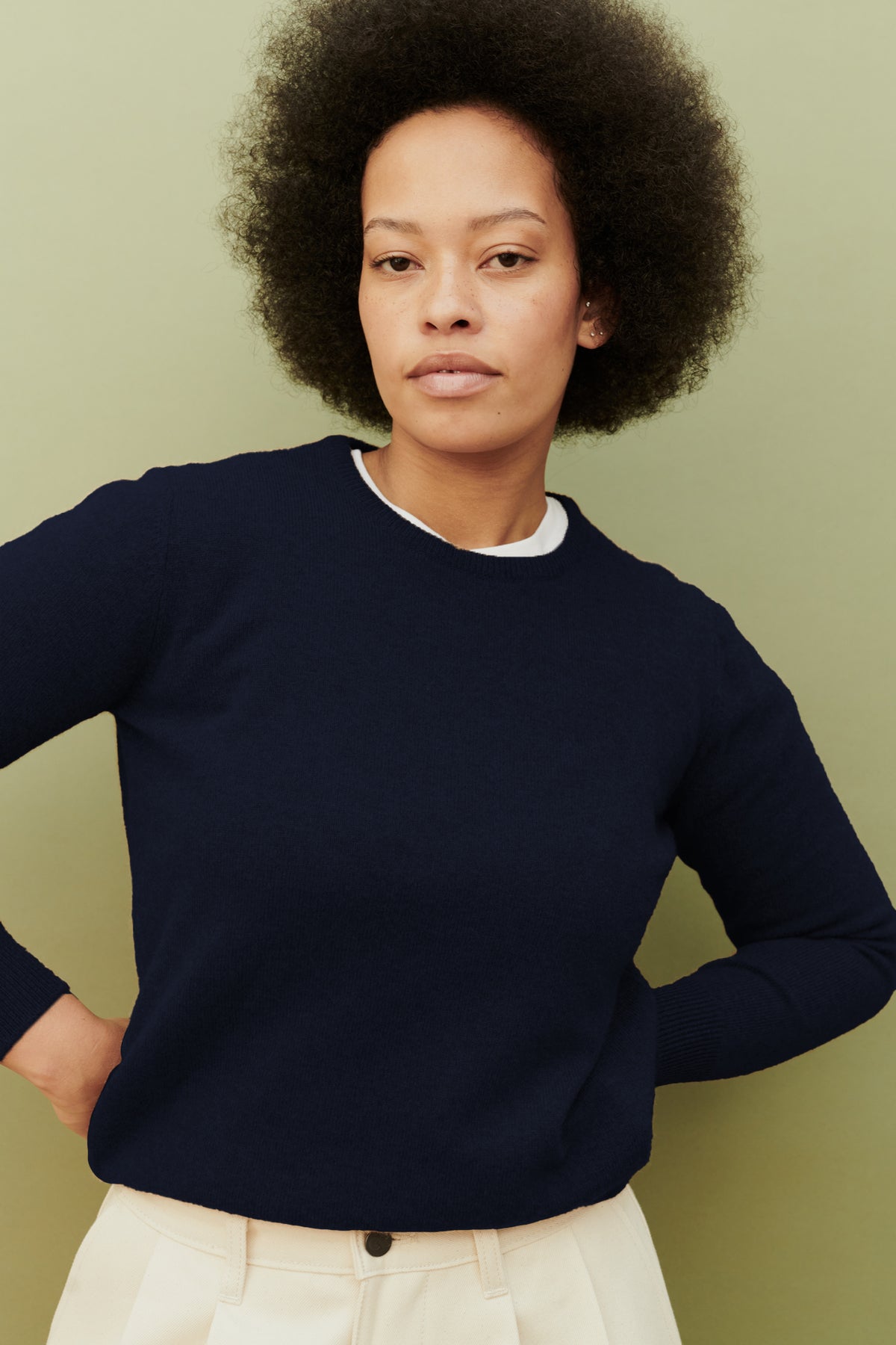 
            Thigh up image of female wearing lambswool crew neck in navy