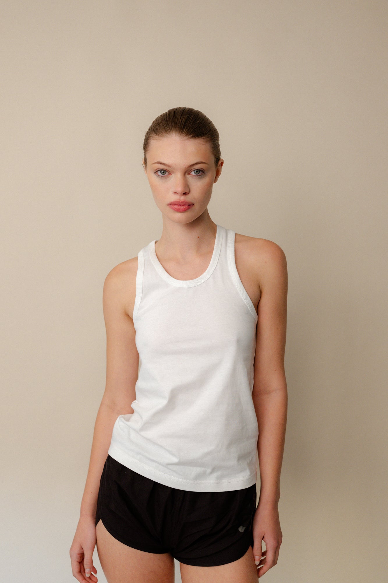 Portrait of female wearing white racer back vest