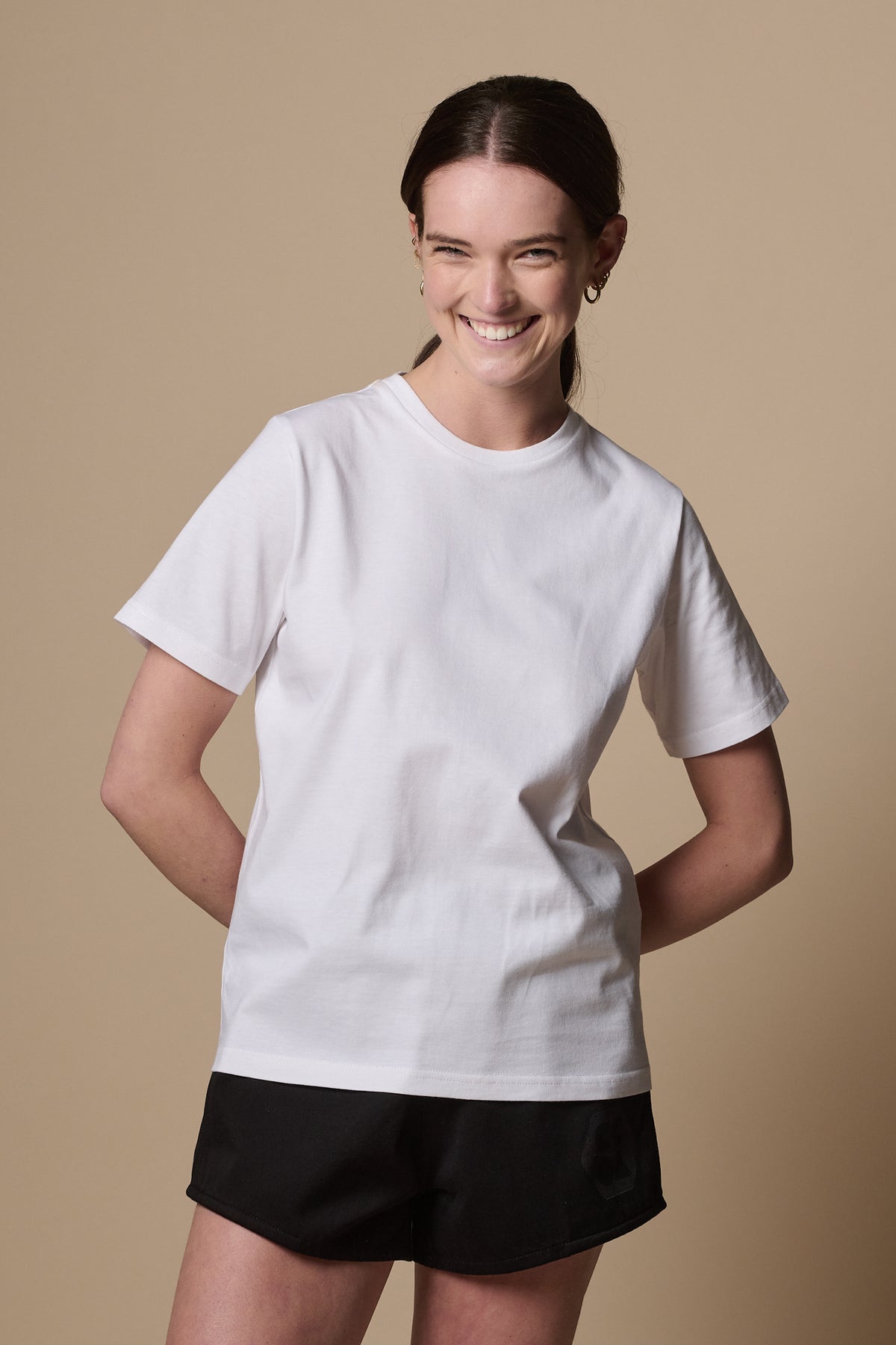 
            Smiley female facing the camera wearing women&#39;s short sleeve crew neck t shirt in white 
