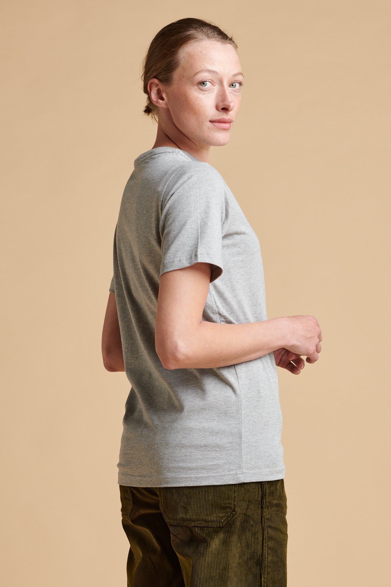 Female wearing short sleeve t shirt in grey marl.