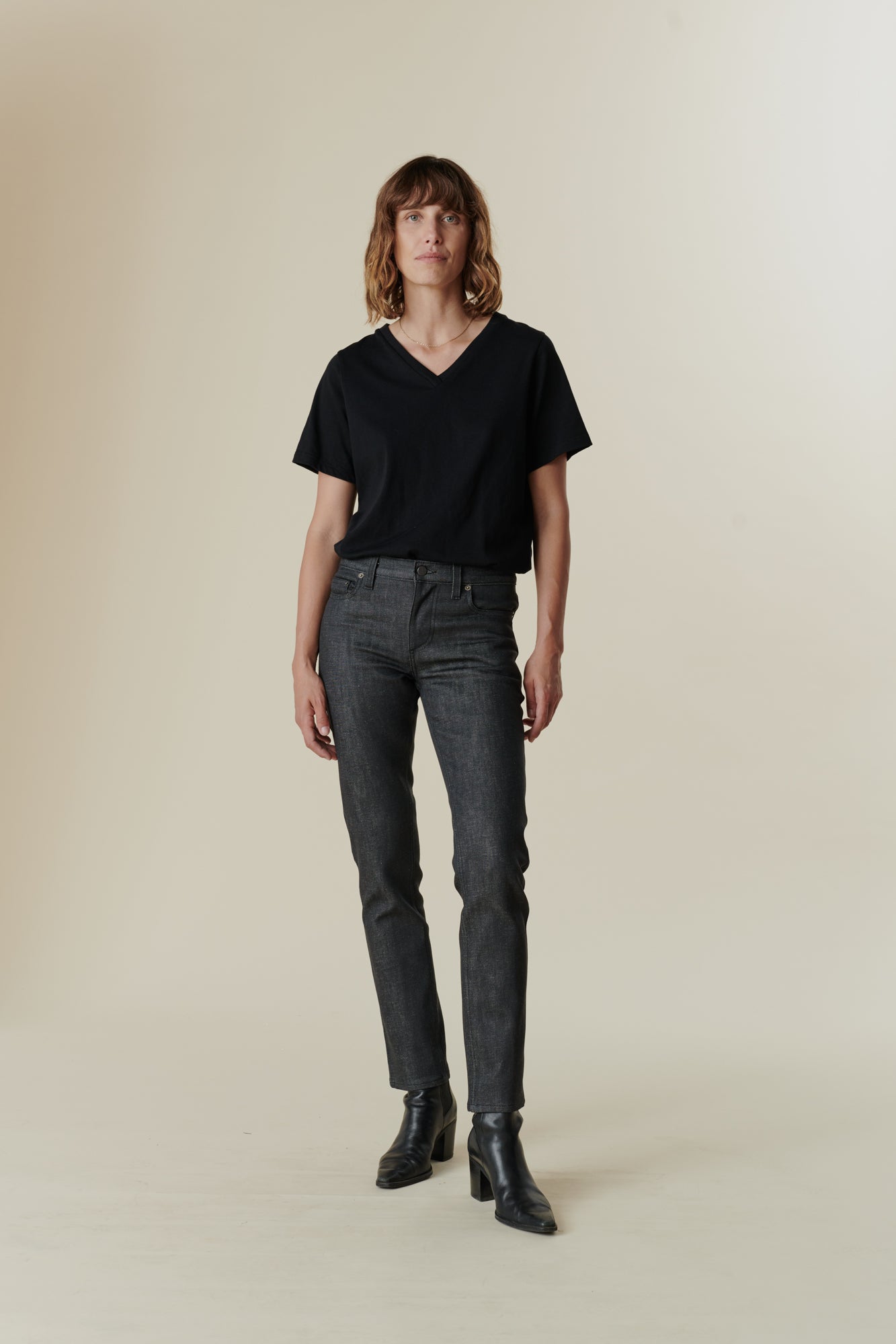 full body image of female wearing black v neck t shirt
