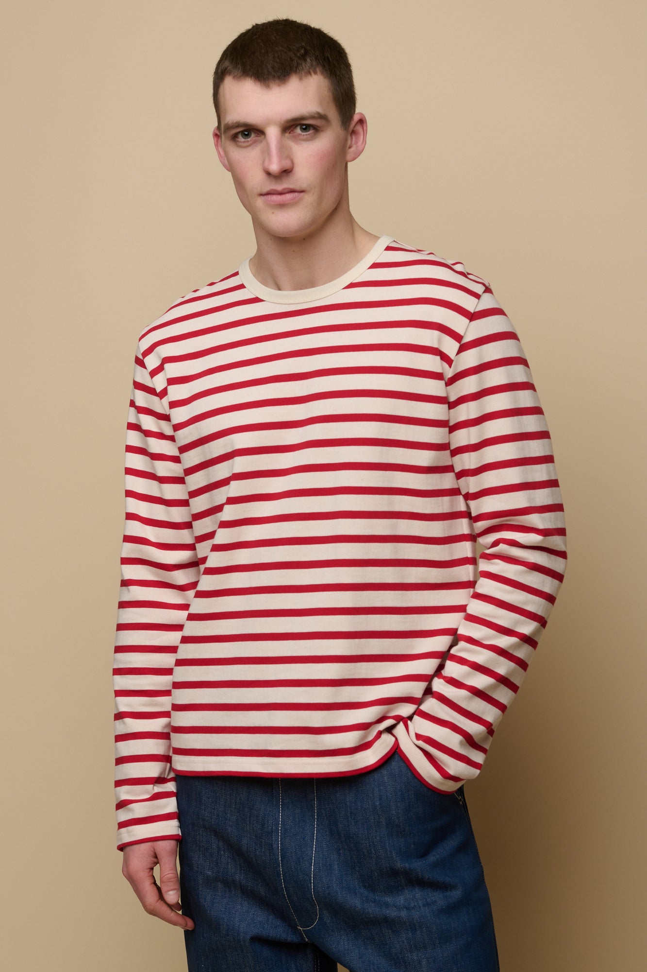 Thigh up front of male wearing ecru/flame red Breton