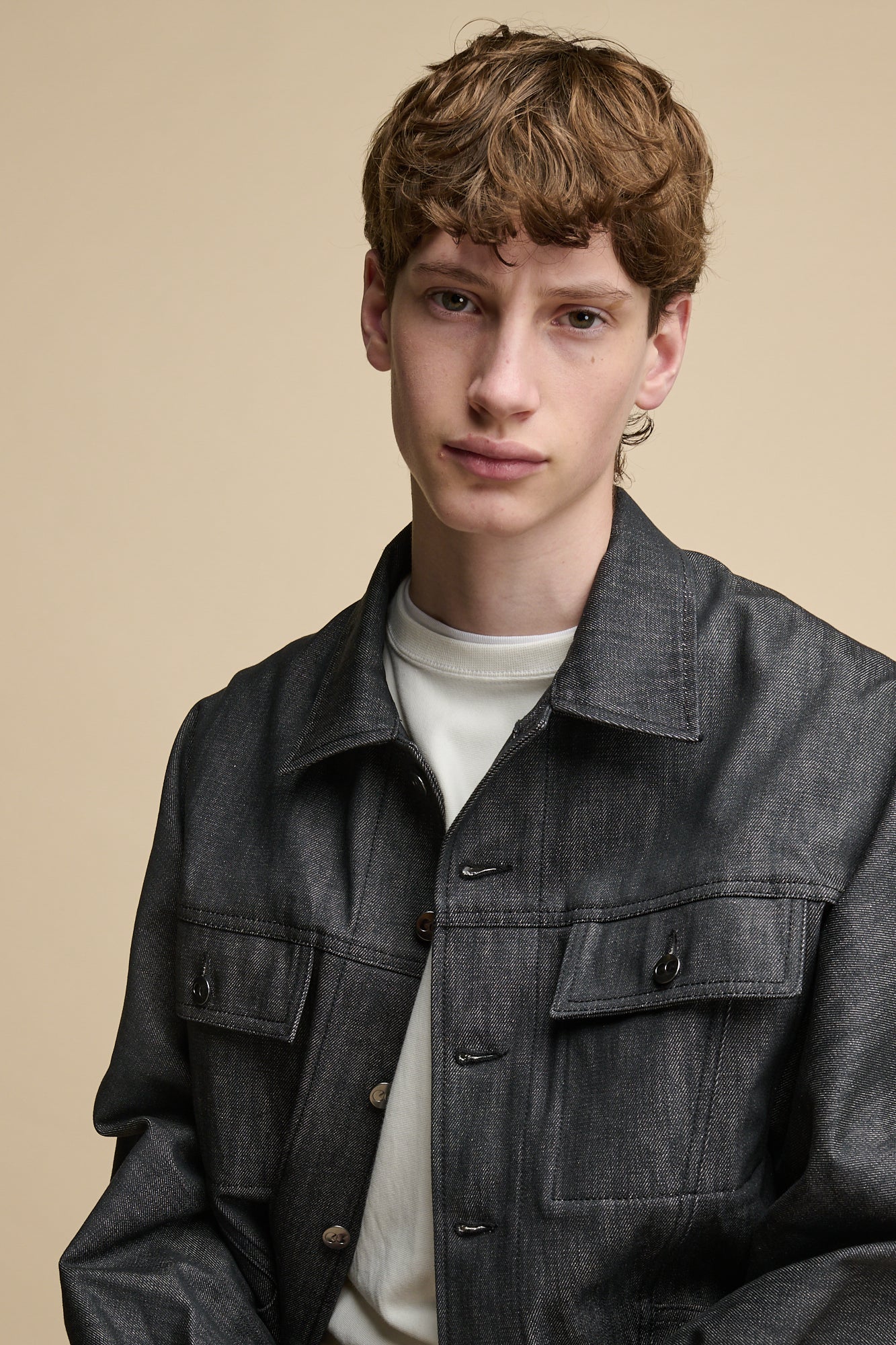 Thigh up image of Men's Joe Denim Jacket in black with two front chest pockets with flaps.