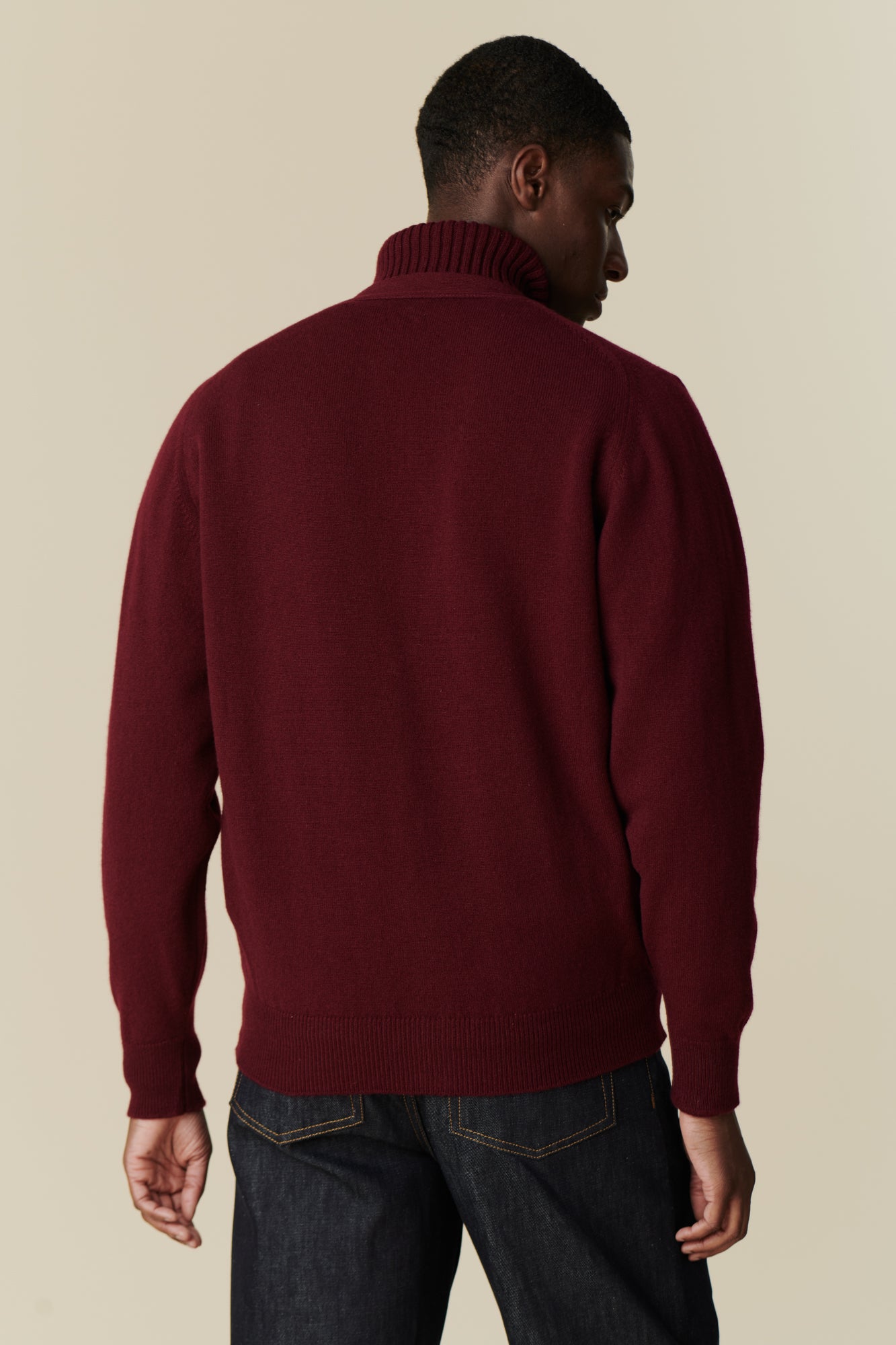 Image of back of male wearing lambswool cardigan in burgundy