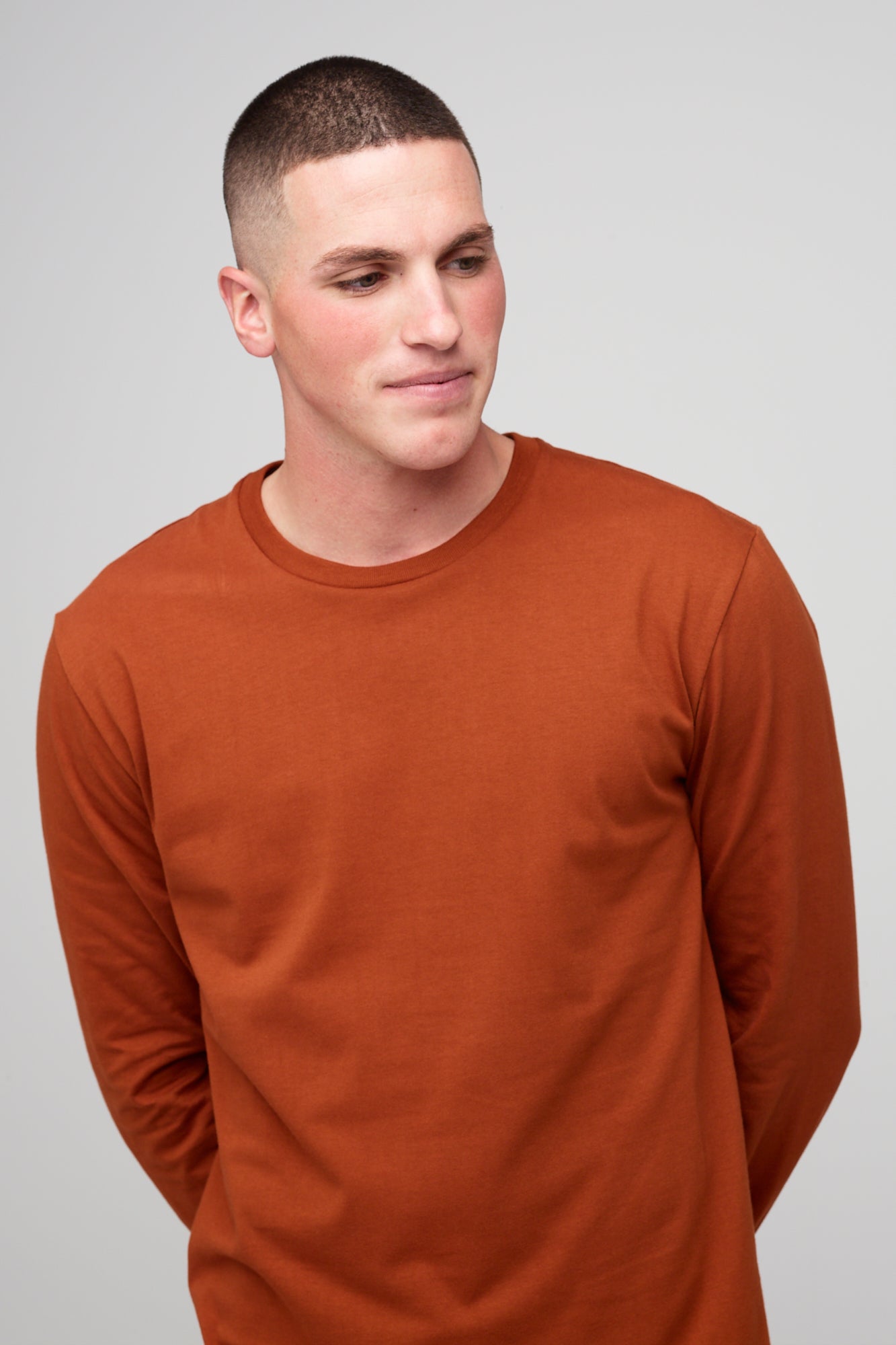 Brunete, white male wearing long sleeve t-shirt in cinnamon  