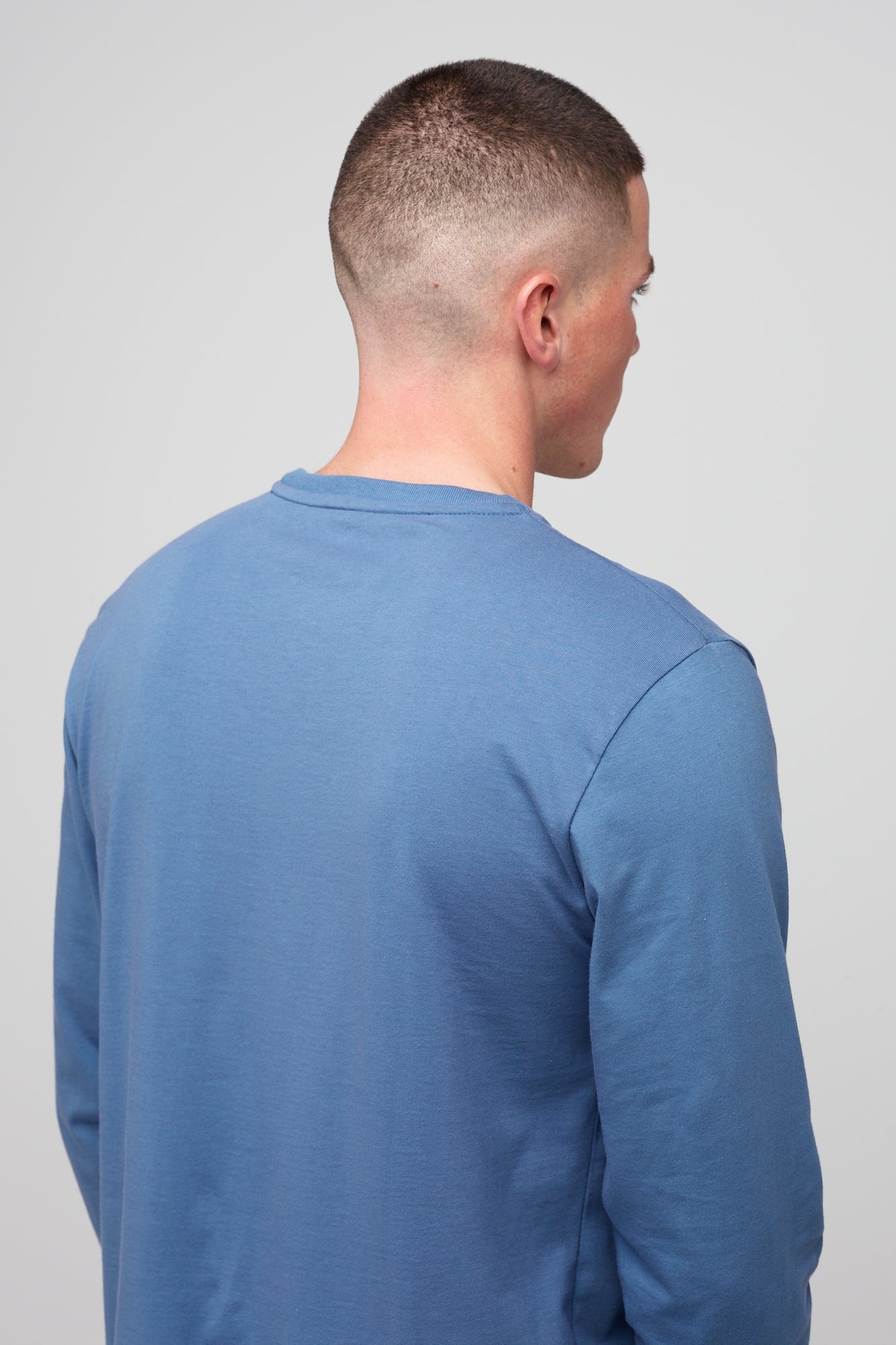 Brunette white male wearing long sleeve t-shirt in RAF blue