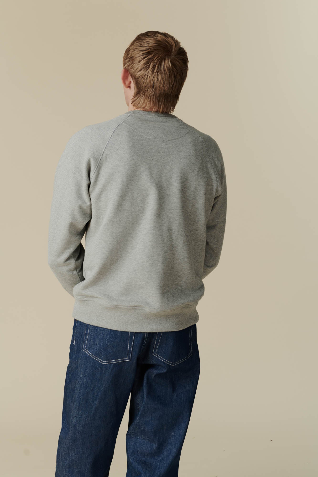 Back of male in raglan sweatshirt grey