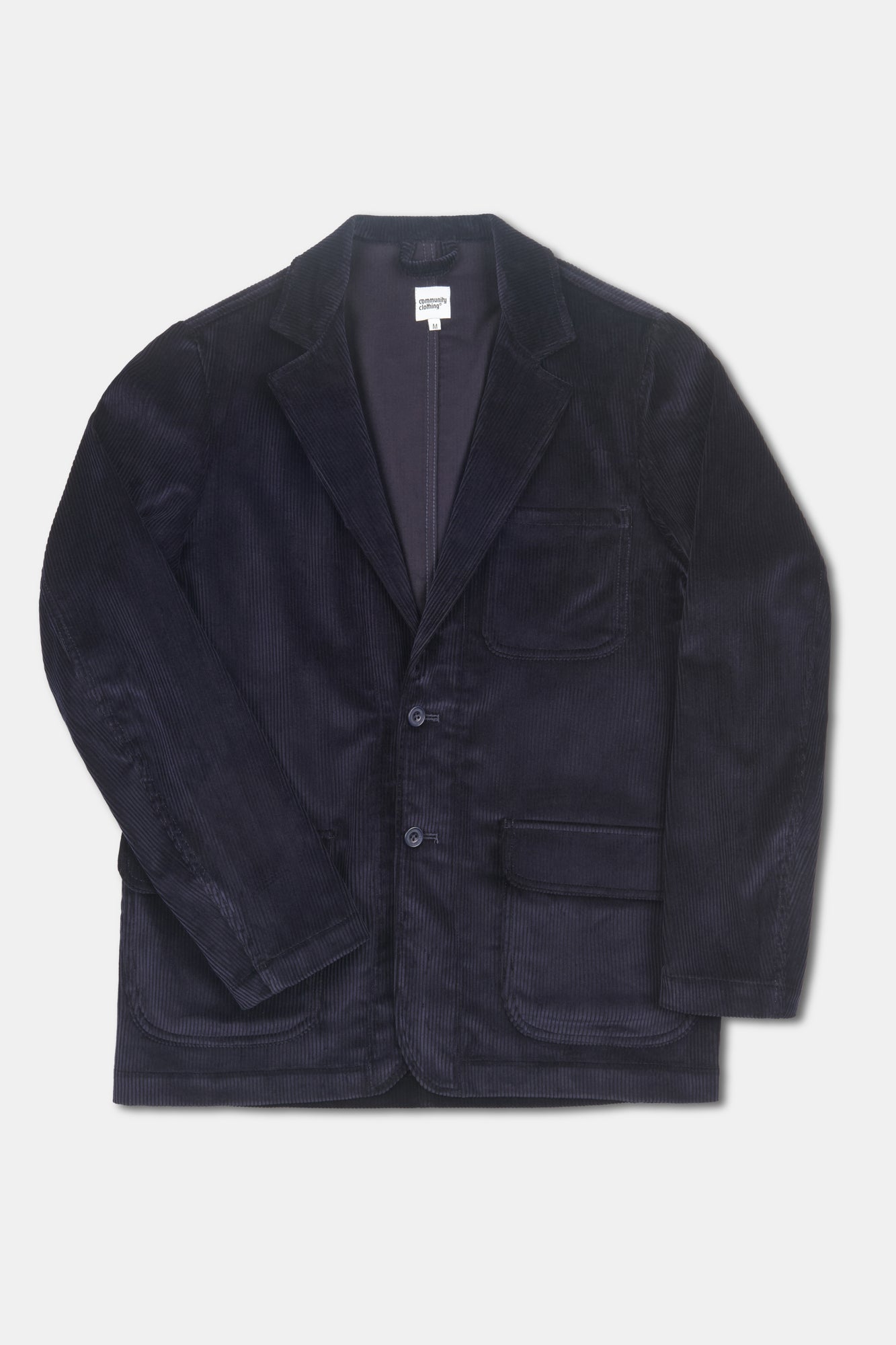 Navy corduroy blazer on pale grey background