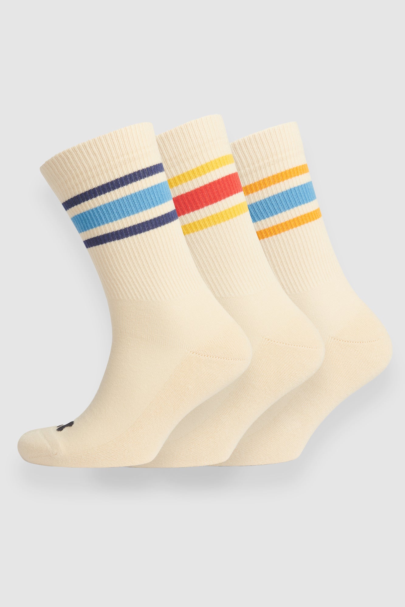Three pairs of cream socks with colorful stripes on a light gray background