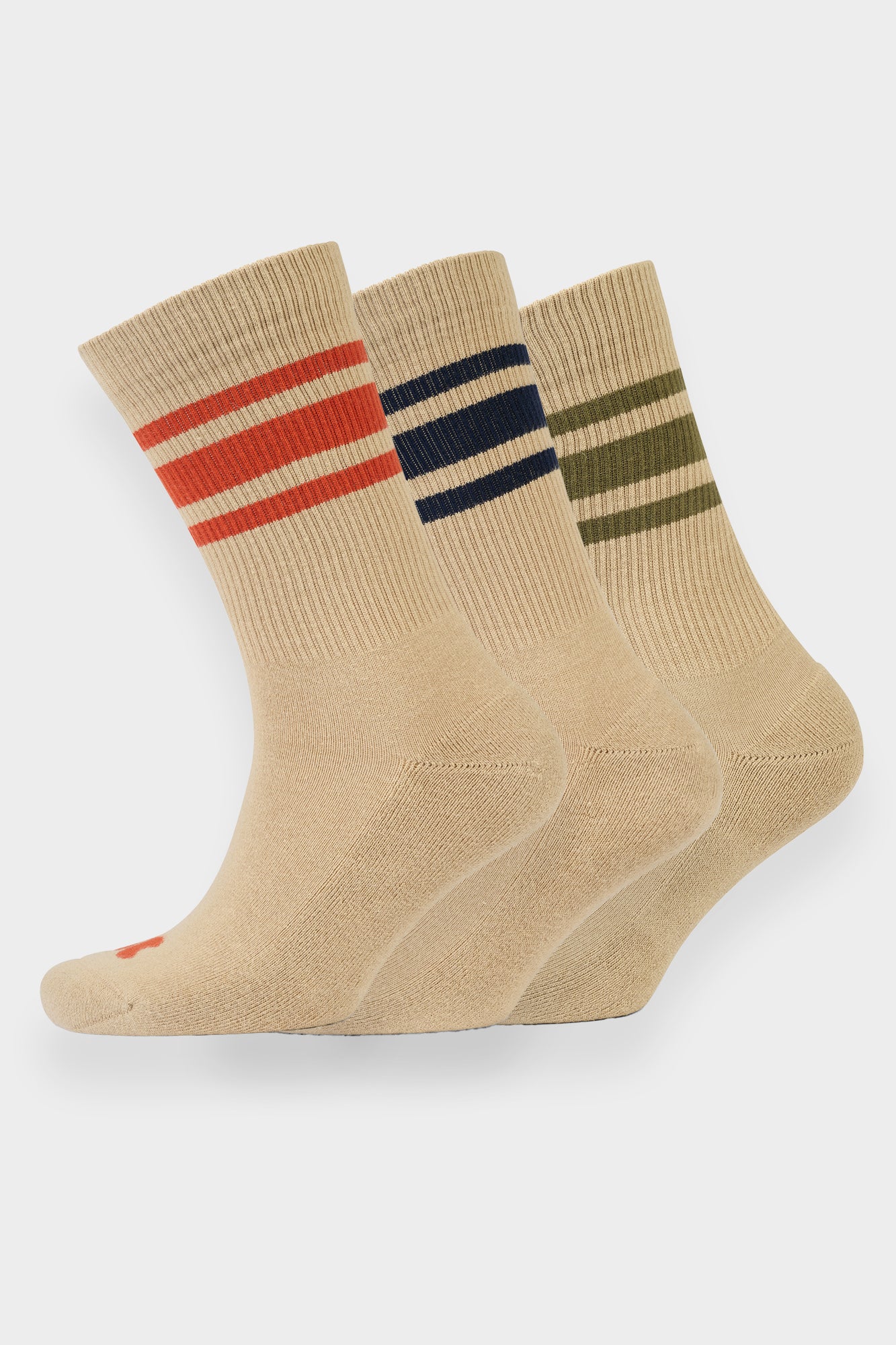 Three pairs of beige socks with colorful stripes on a white background