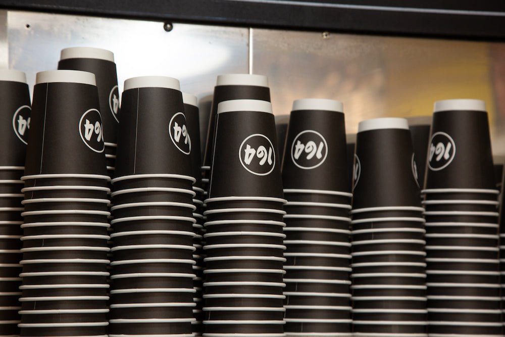 woman wearing community clothing outside a cafe in leeds