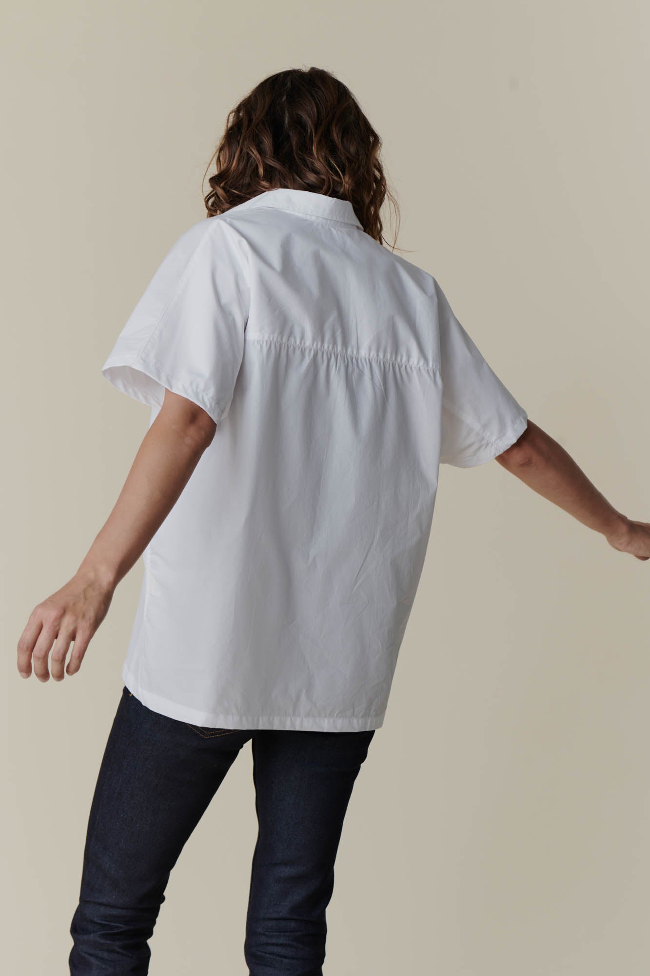 The back of female wearing Ava short sleeve shirt in white  