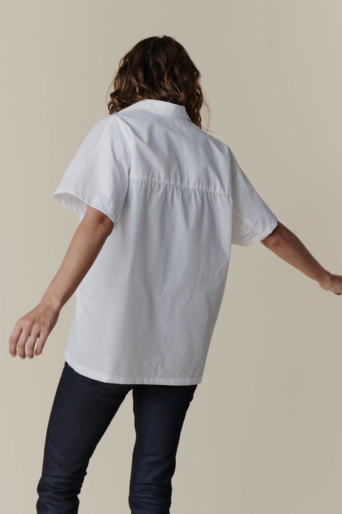 
            The back of female wearing Ava short sleeve shirt in white  