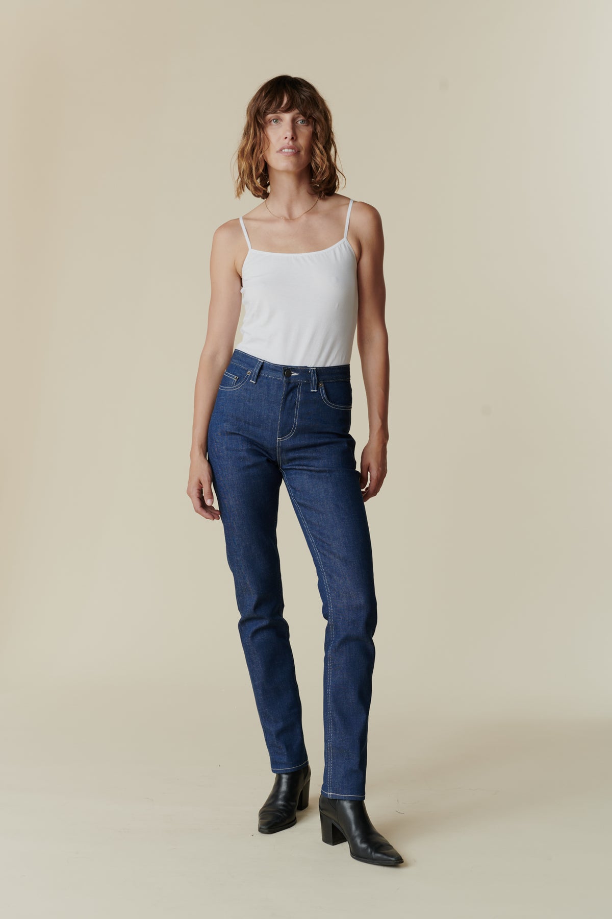 
            Front full body image female wearing straight leg high rise jean in blue.