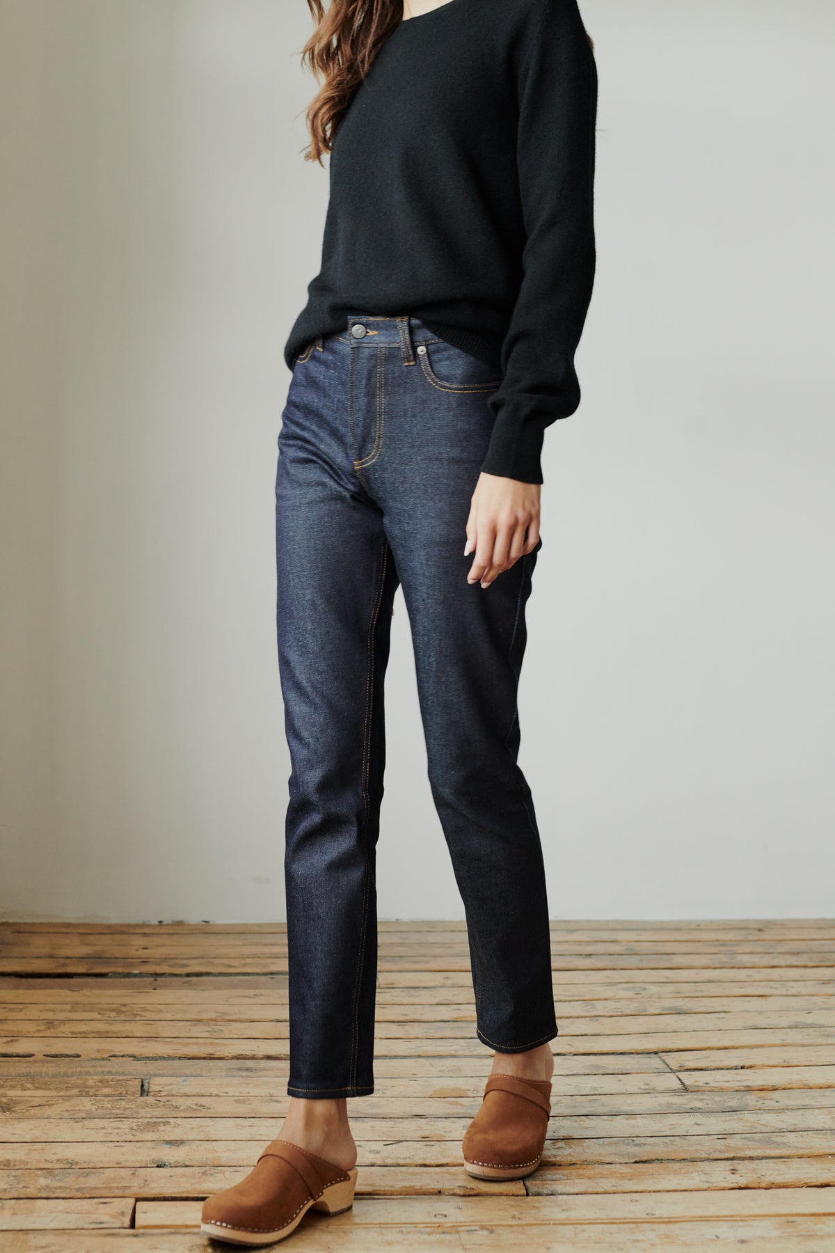 Front of female wearing straight leg high rise jean in indigo.