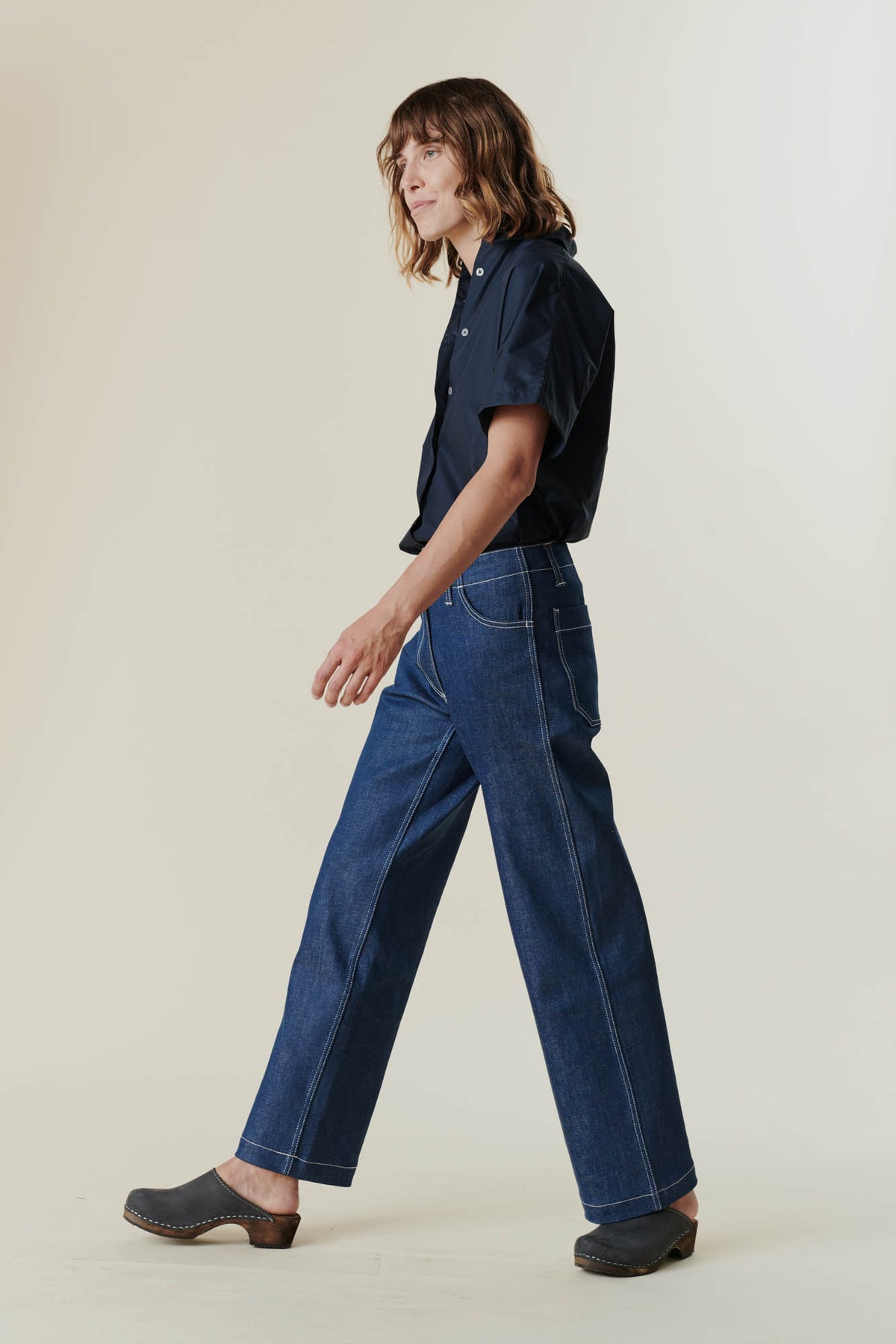 Female wearing work jean in blue side
