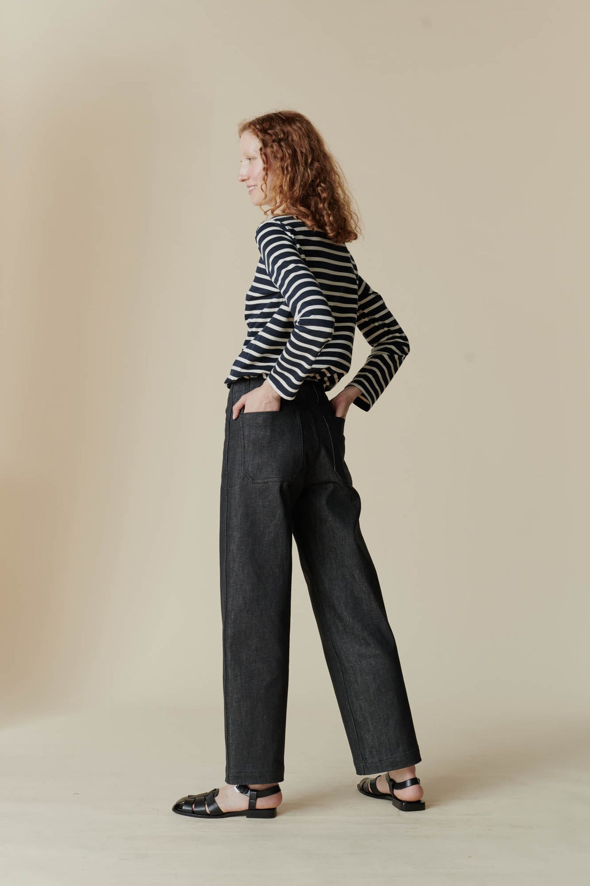 Female wearing work jean in black Showing back pockets