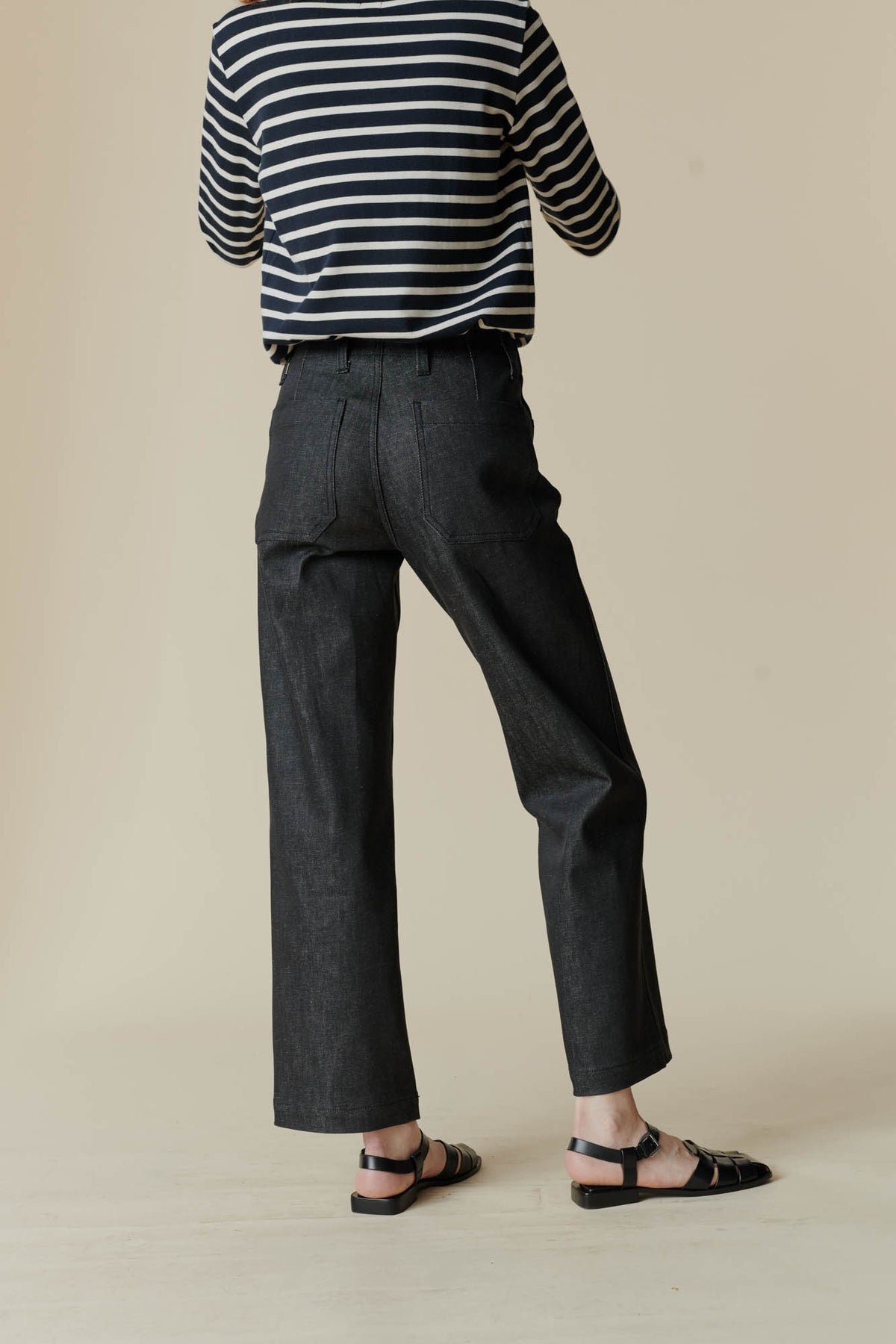 Female wearing work jean in black back