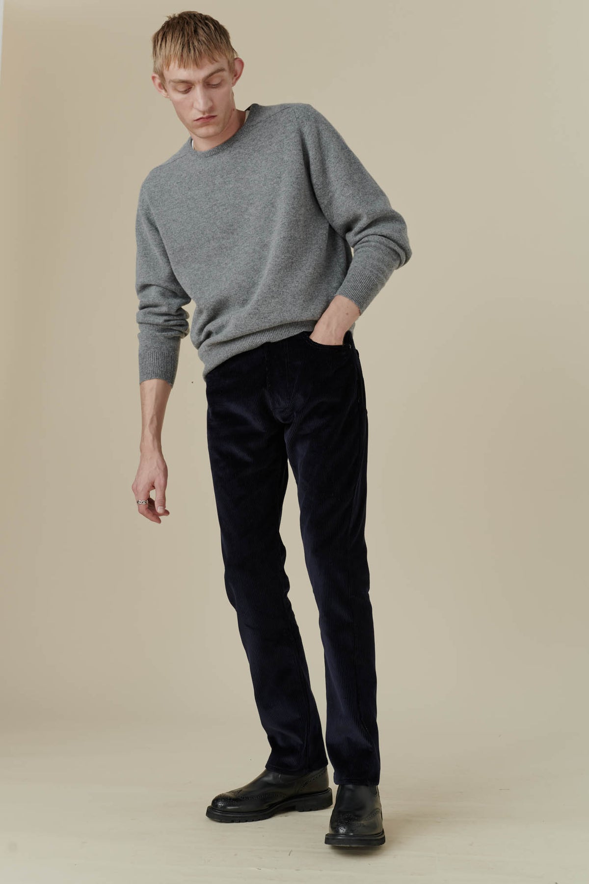 Male wearing five pocket cord trousers in navy