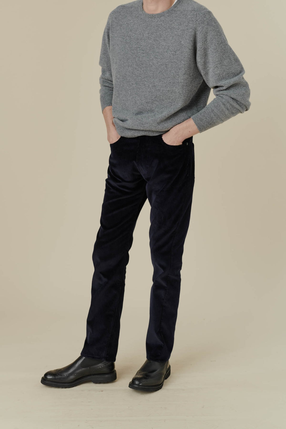 Male wearing five pocket cord trousers in navy
