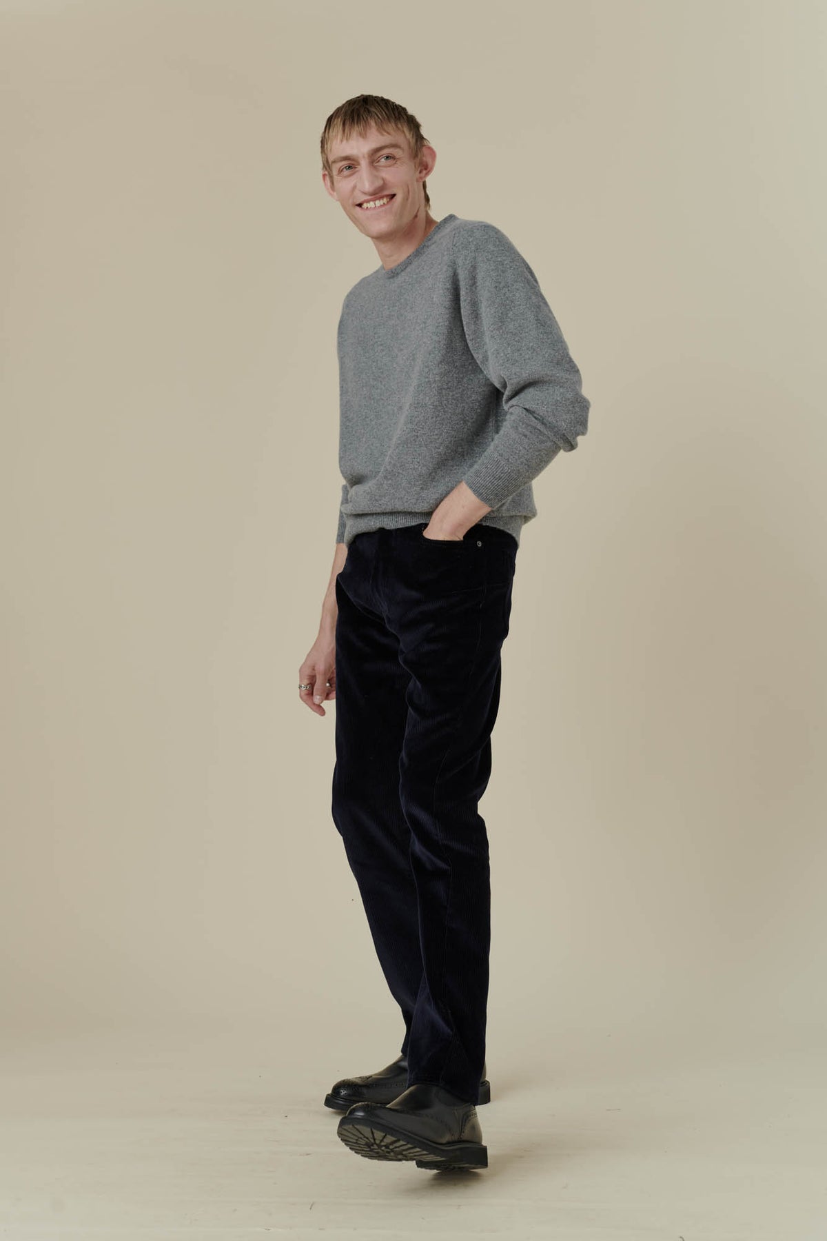 Male wearing five pocket cord trousers in navy