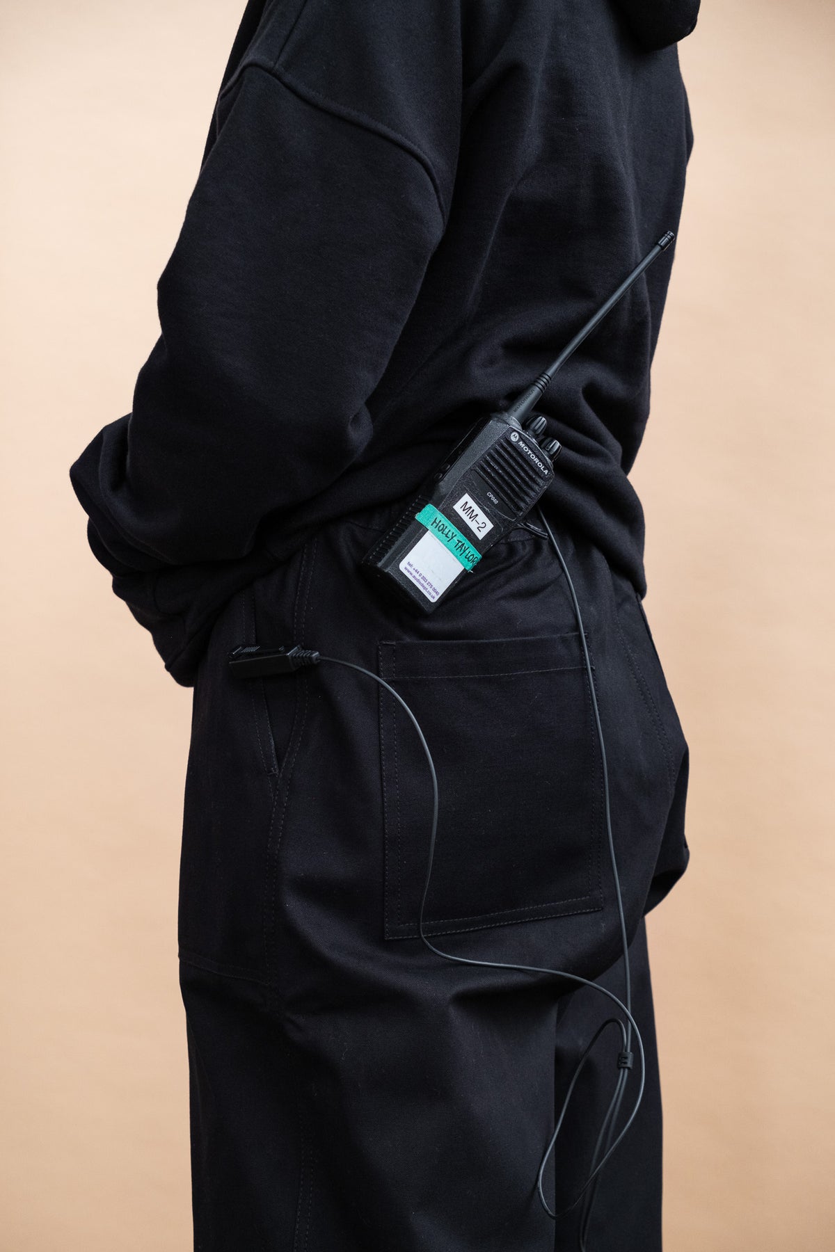 
            Female wearing camerawoman drawstring trousers in black and camera equipment attached to the waistband. two back pockets