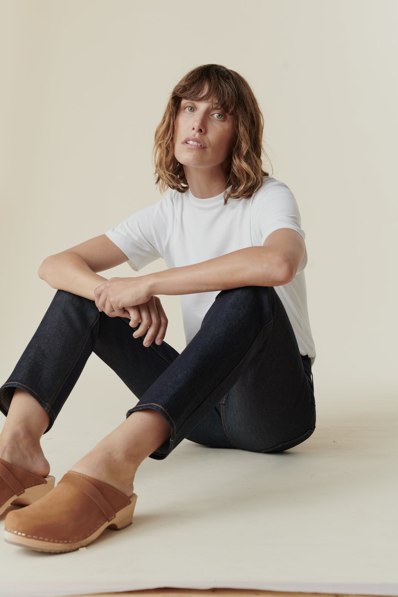 Female wearing mid rise straight leg jean in Indigo