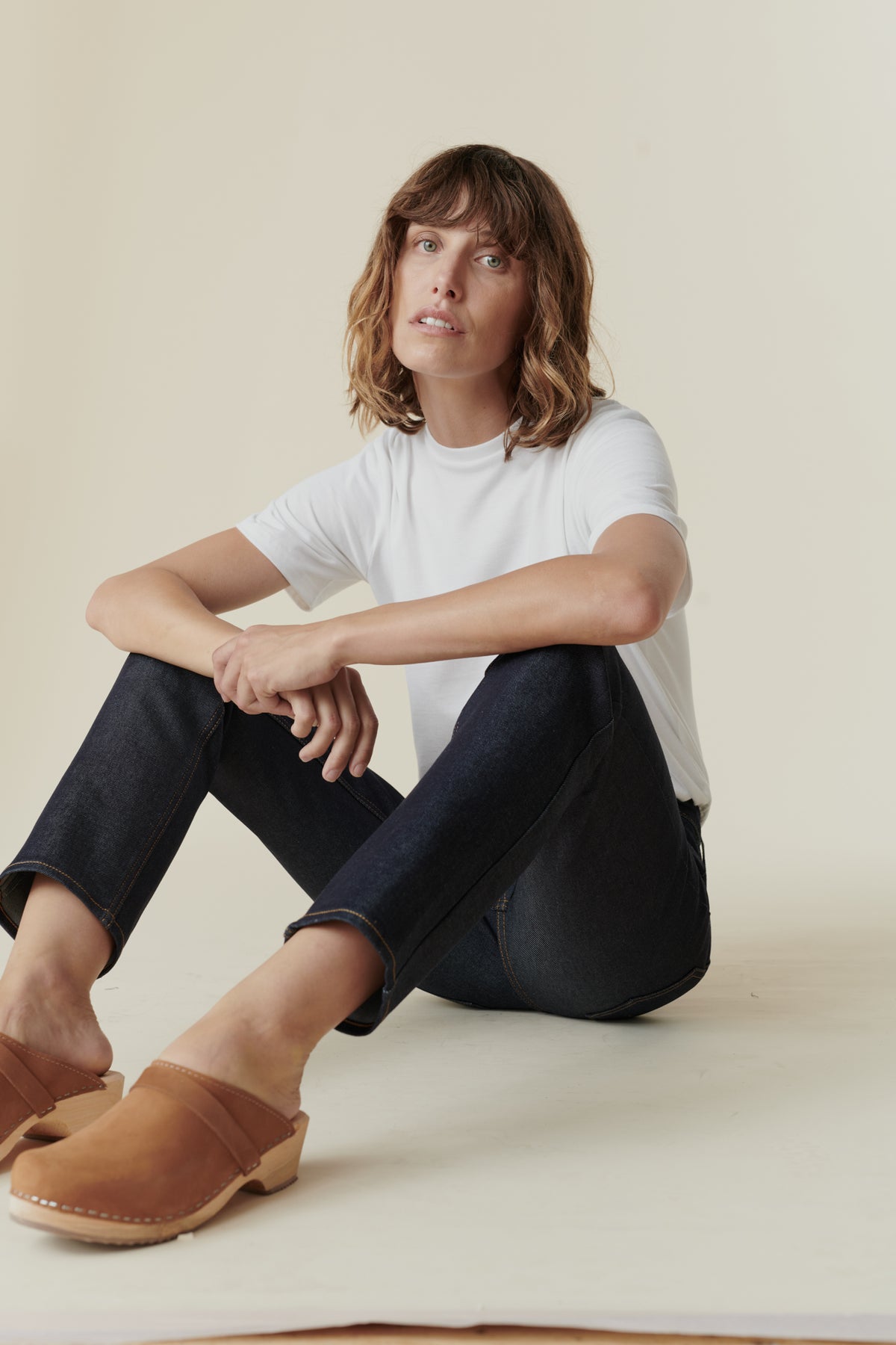 Female wearing mid rise straight leg jean in Indigo