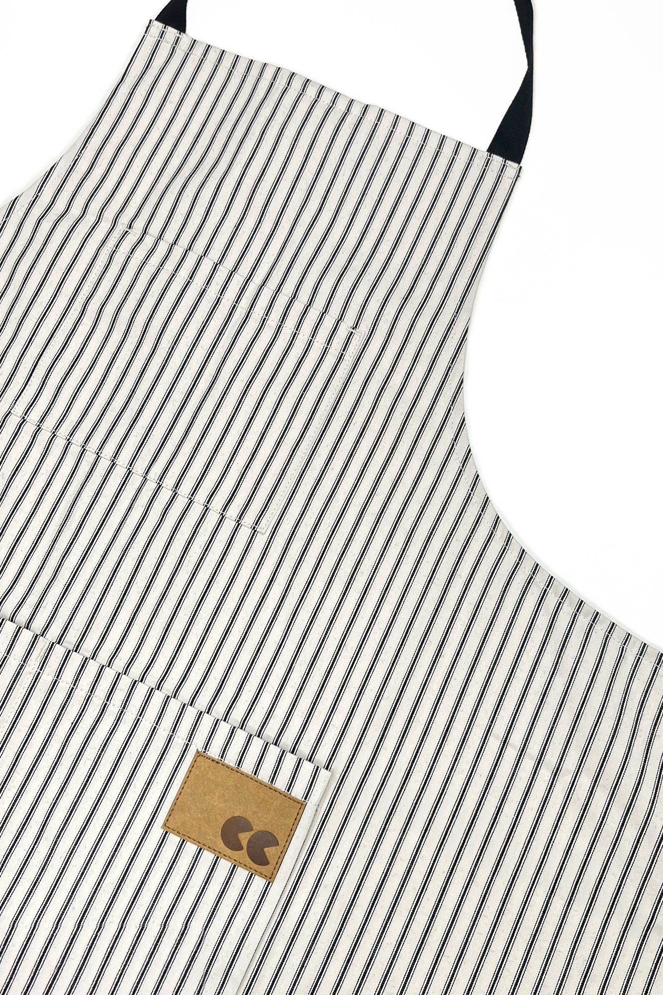 Striped apron with a brown leather patch on a white background