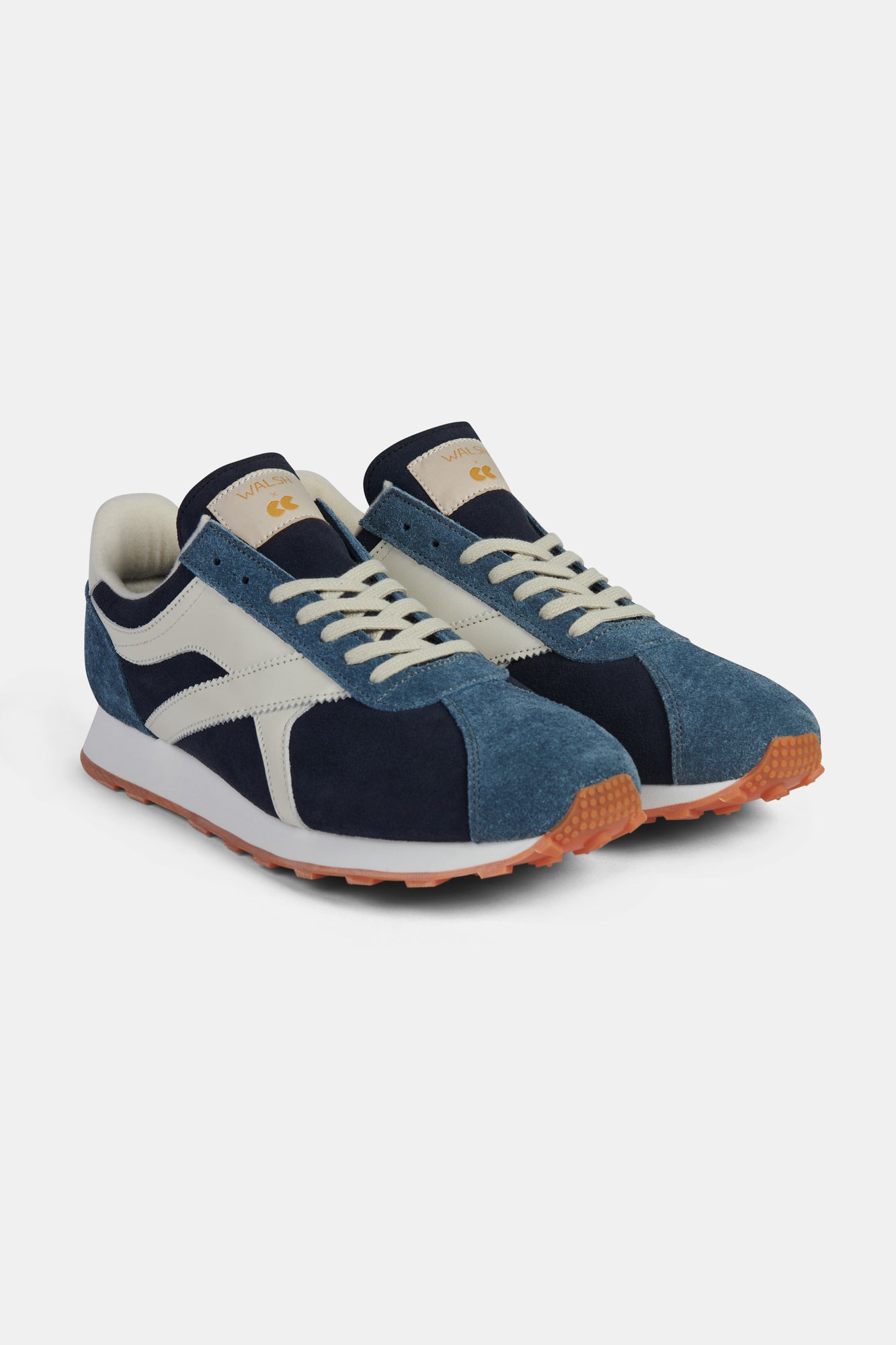 Pair of blue and white trainers on a white background.