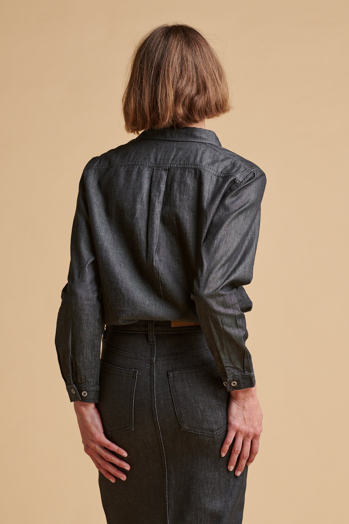Female wearing Olivia half placket lightweight denim shirt in black.