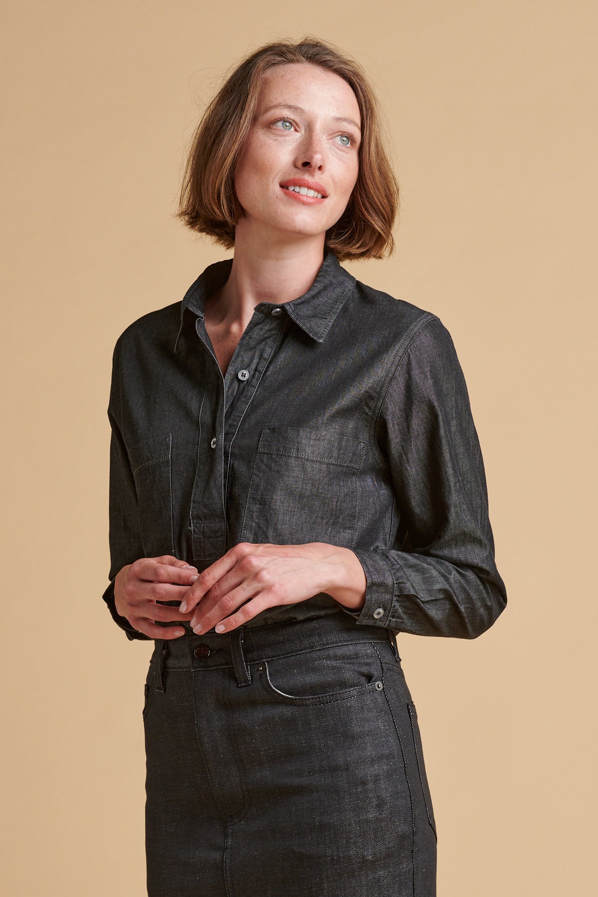 Female wearing Olivia half placket lightweight denim shirt in black.