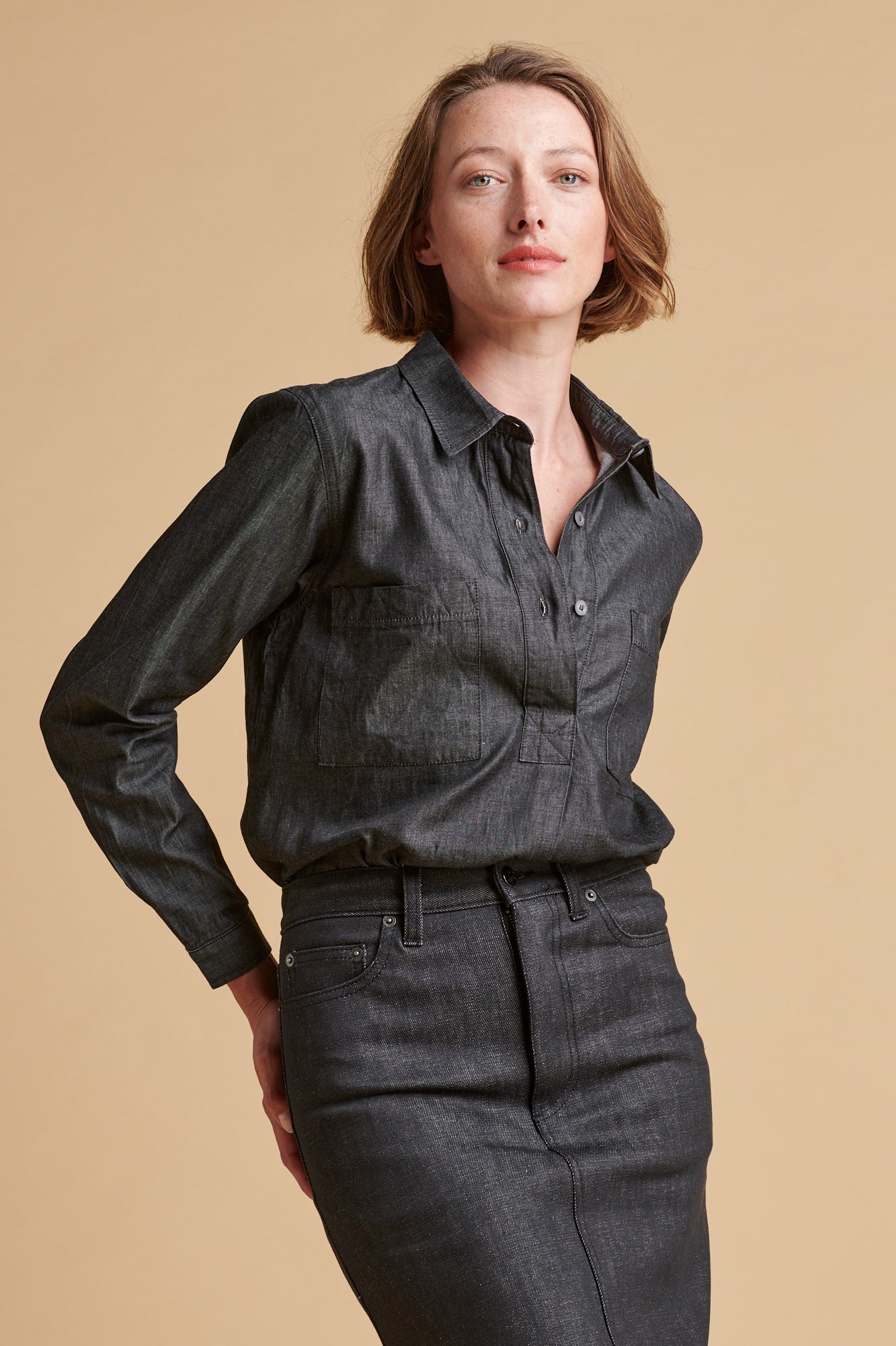 Female wearing Olivia half placket lightweight denim shirt in black.