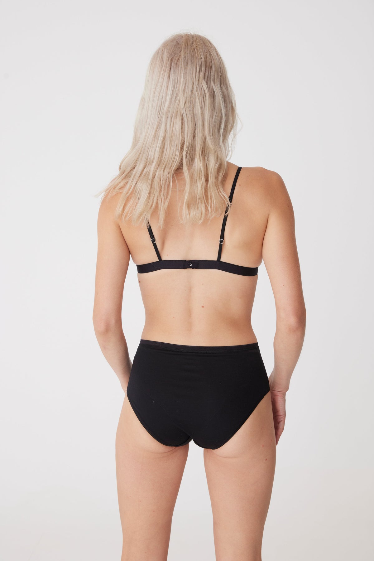 Blonde female wearing black bralette