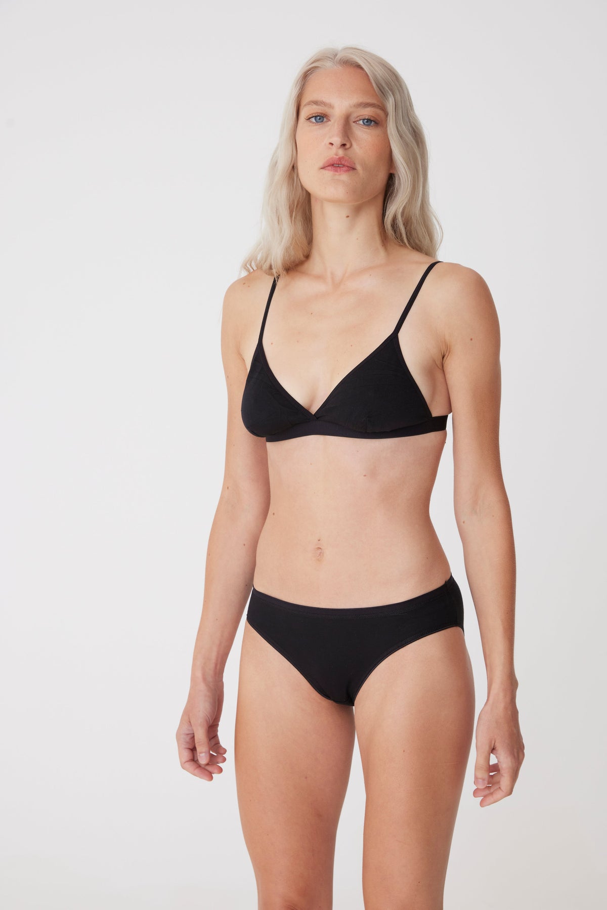 Blonde female wearing black bralette