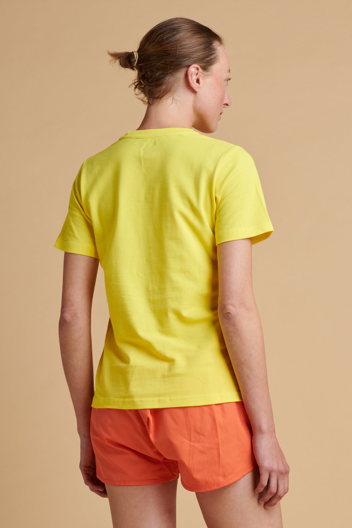 Female wearing breathable t shirt in canary yellow.