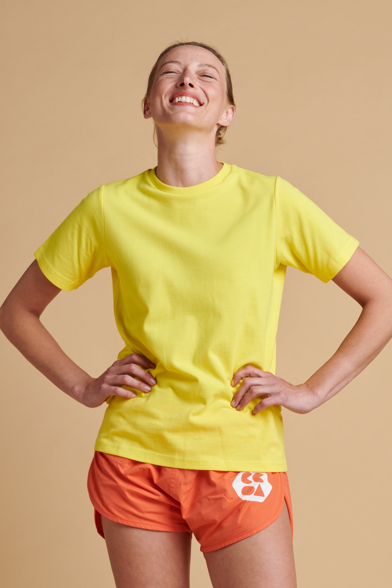 Female wearing breathable t shirt in canary yellow.