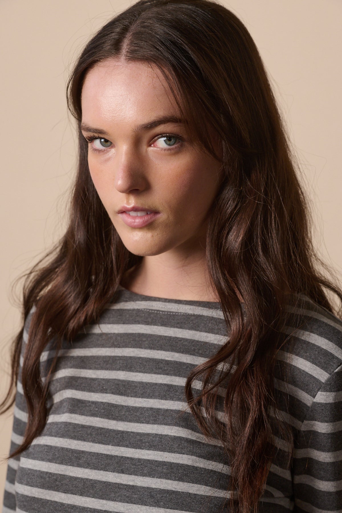 
            Portrait of white female with long brunette hair wearing Breton in charcoal marl and grey marl 