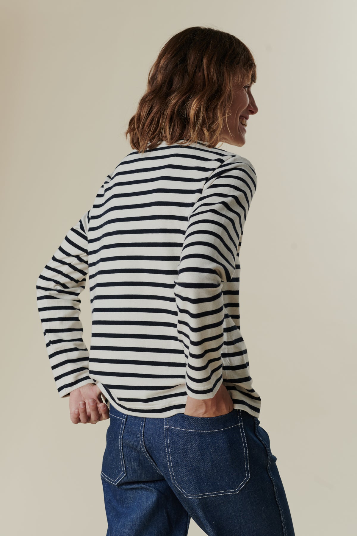 Image of back of female wearing breton in ecru navy
