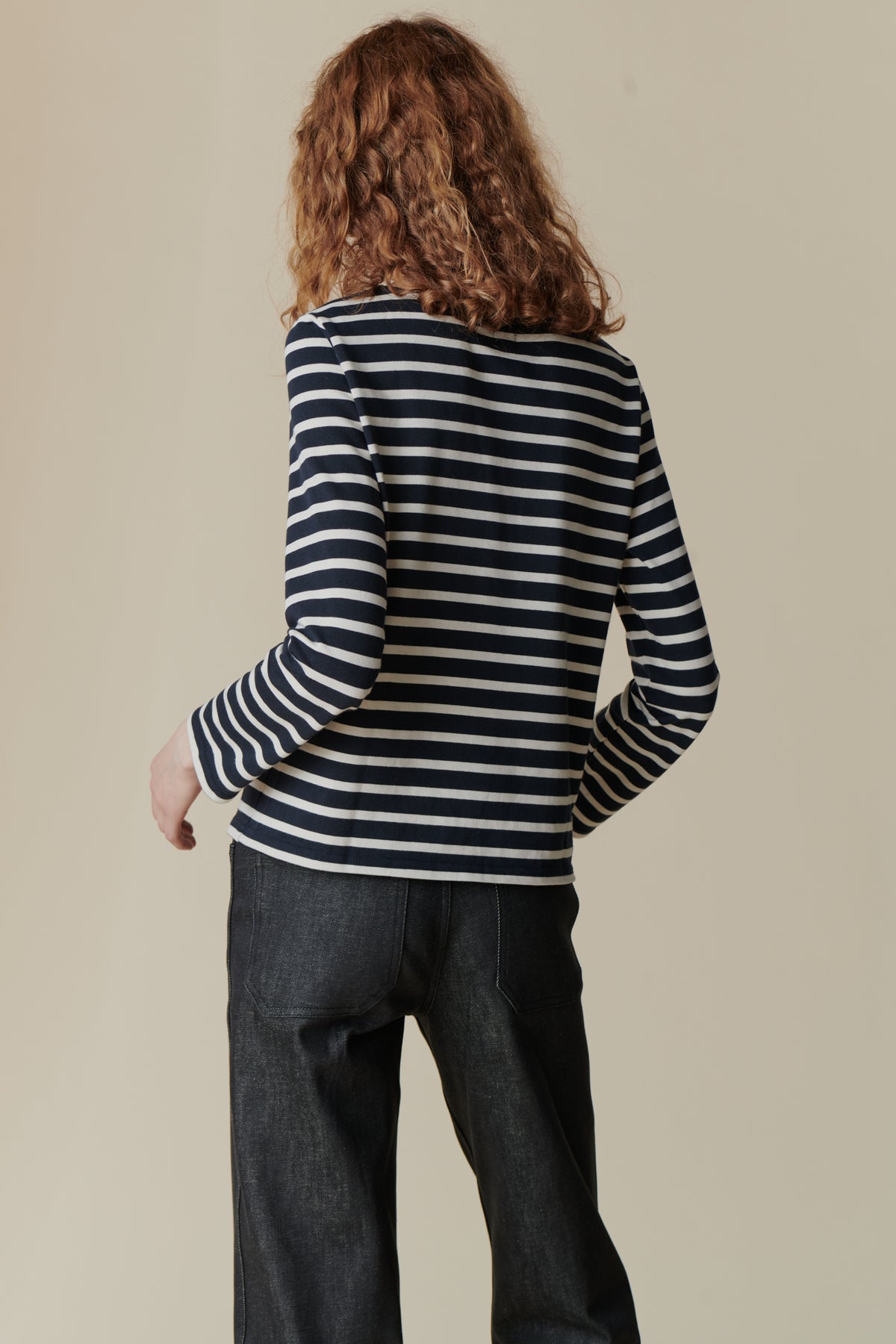 The back of female wearing breton in navy ecru